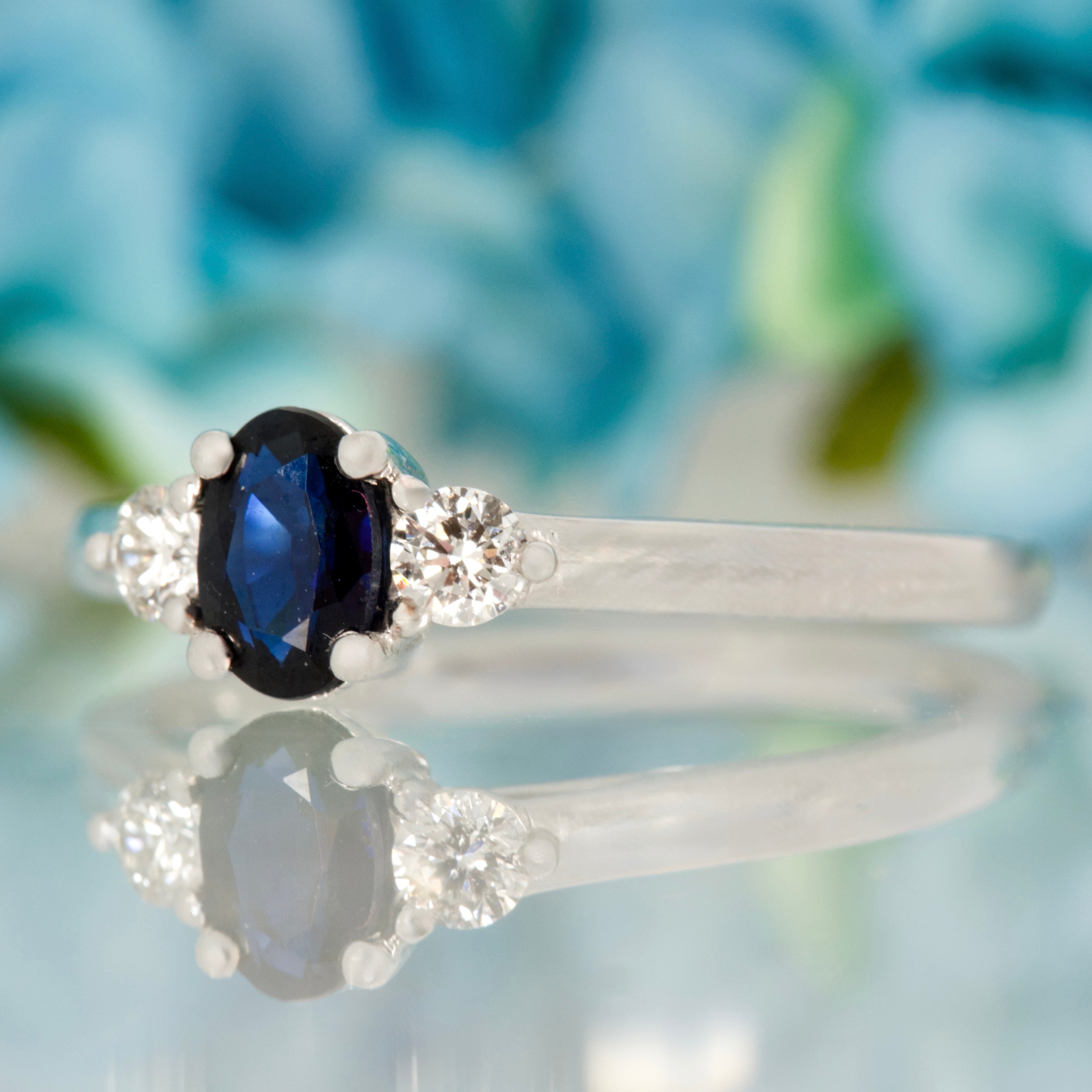 Platinum Oval Cut Sapphire & Round Brilliant Cut Diamond Trilogy Ring