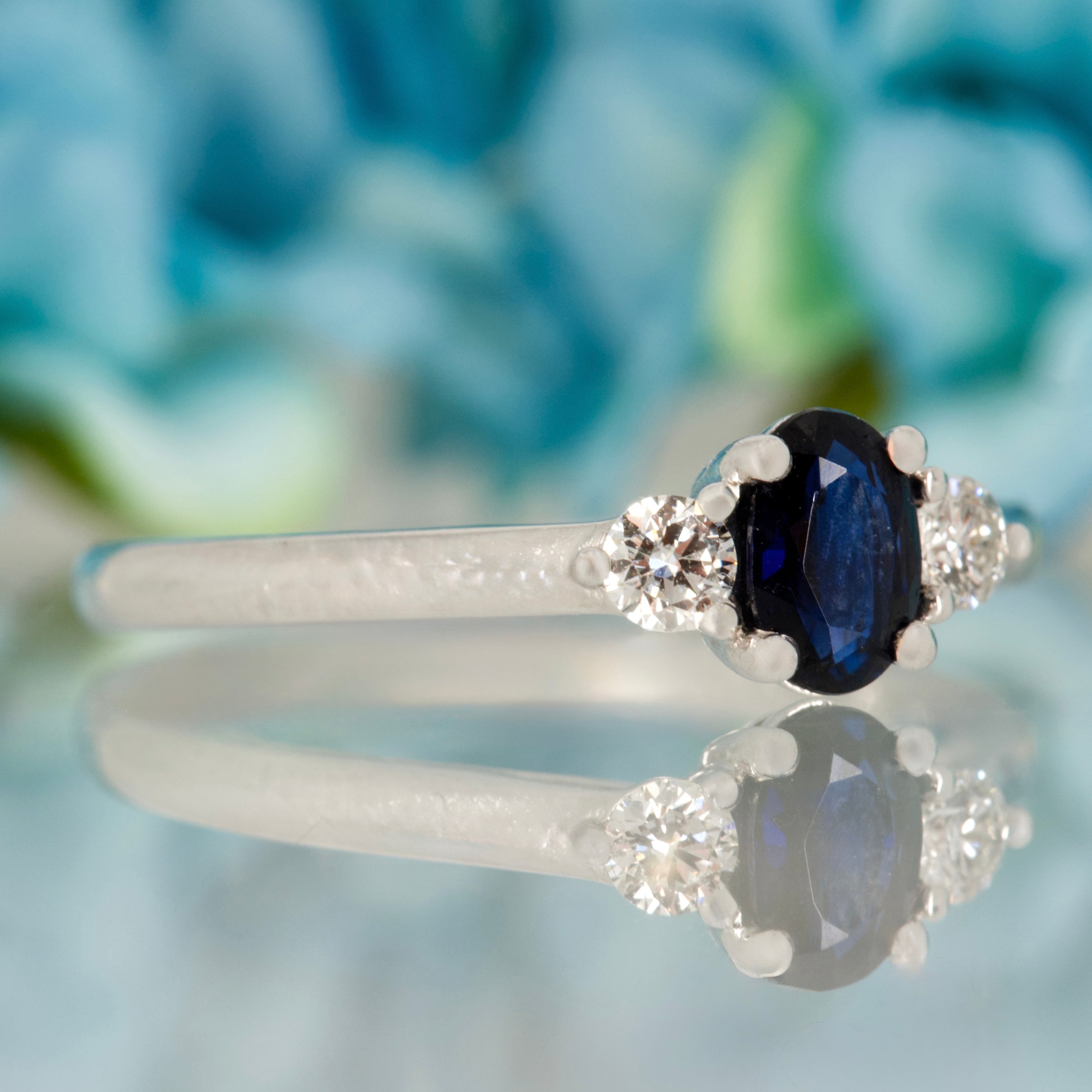 Platinum Oval Cut Sapphire & Round Brilliant Cut Diamond Trilogy Ring