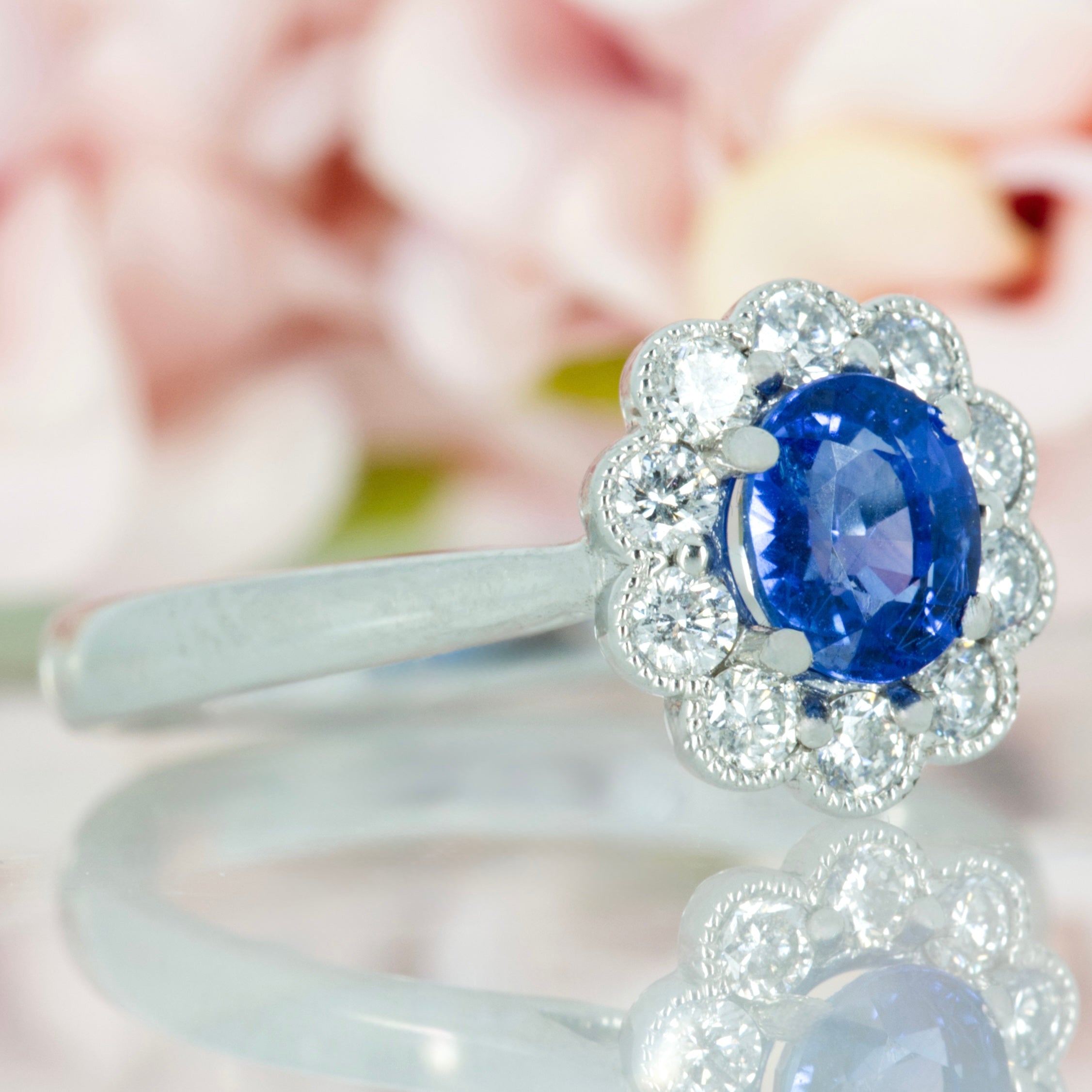 Platinum Oval Cut Sapphire & Round Brilliant Cut Diamond Cluster Ring