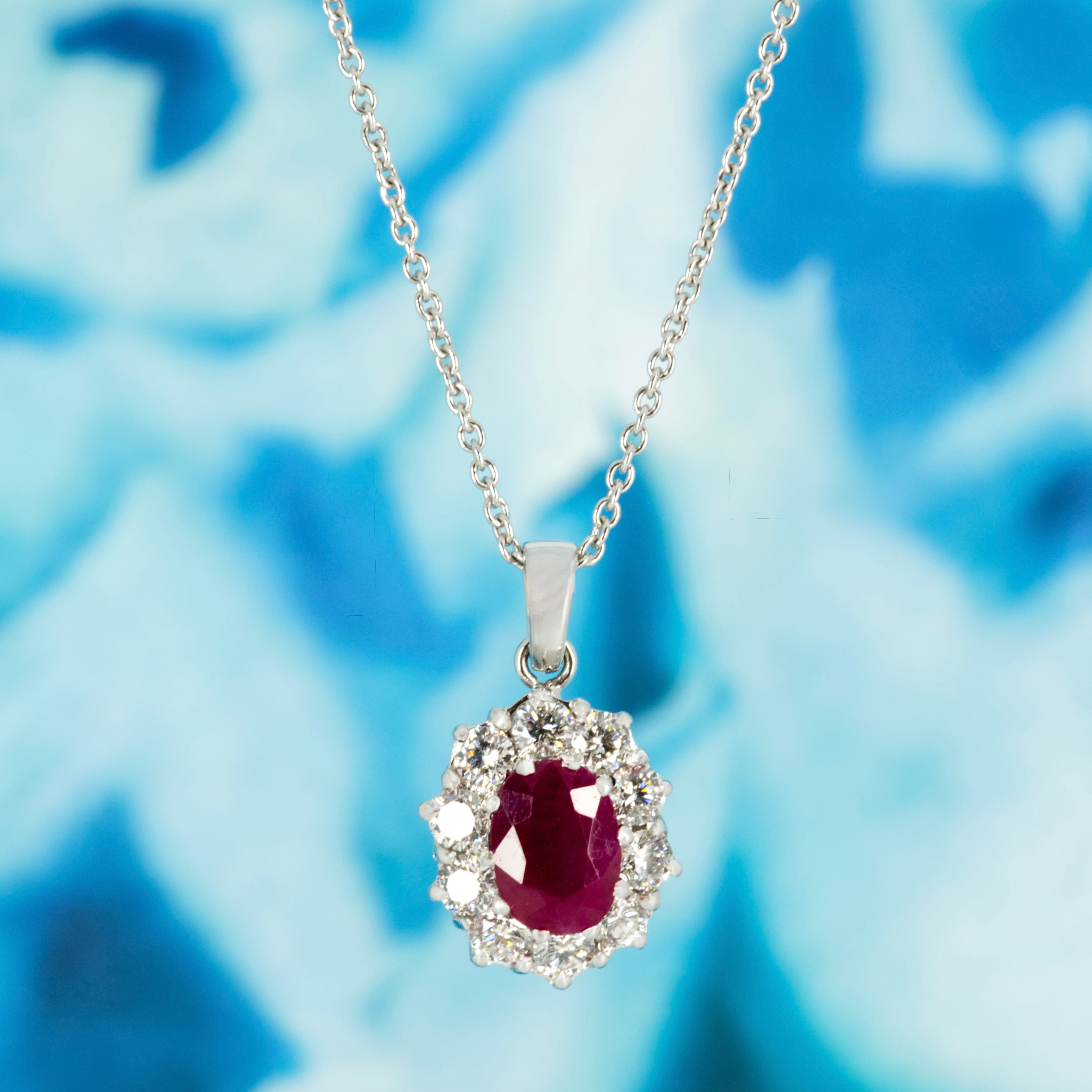 18ct White Gold Oval Cut Ruby & Round Brilliant Cut Diamond Cluster Pendant & Chain