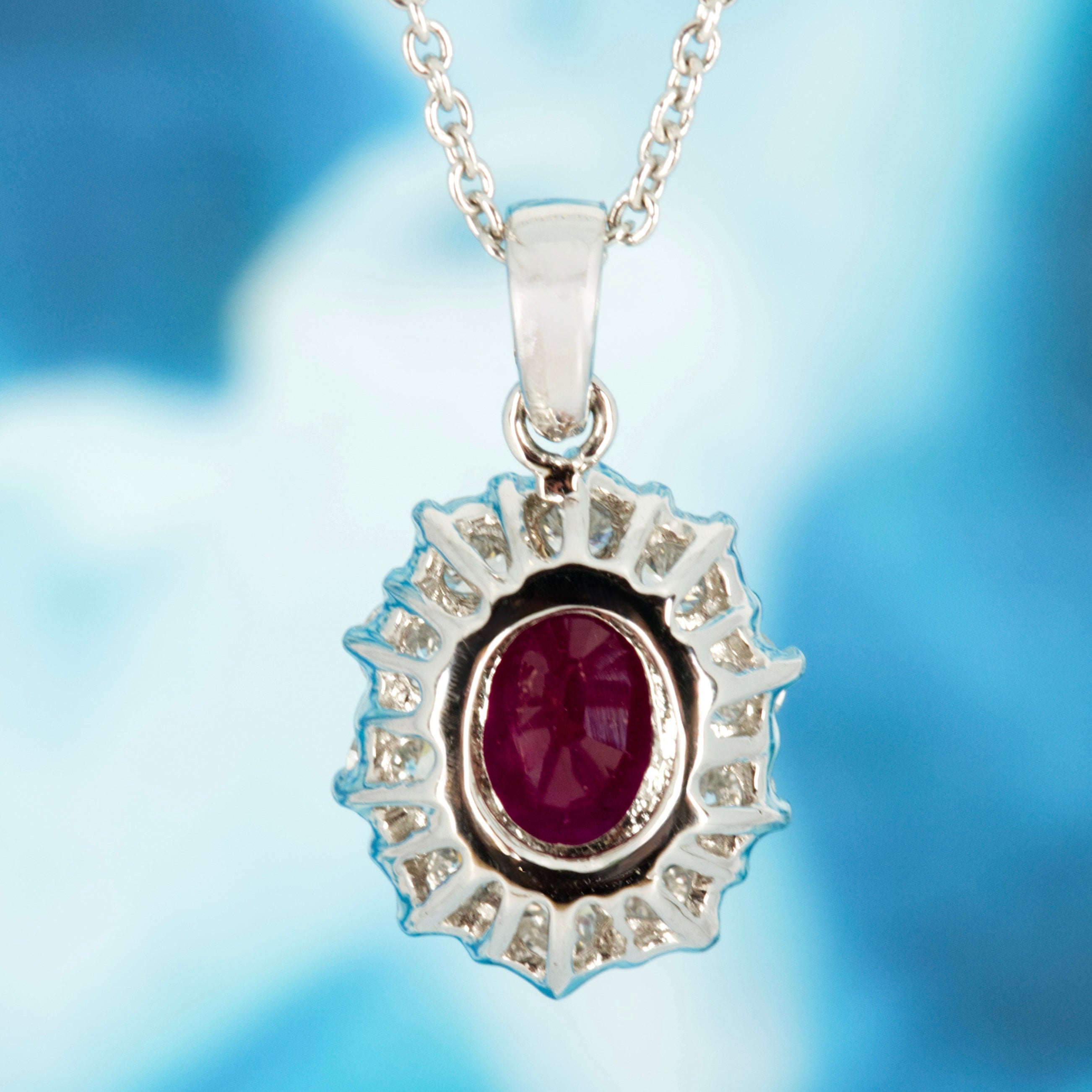 18ct White Gold Oval Cut Ruby & Round Brilliant Cut Diamond Cluster Pendant & Chain