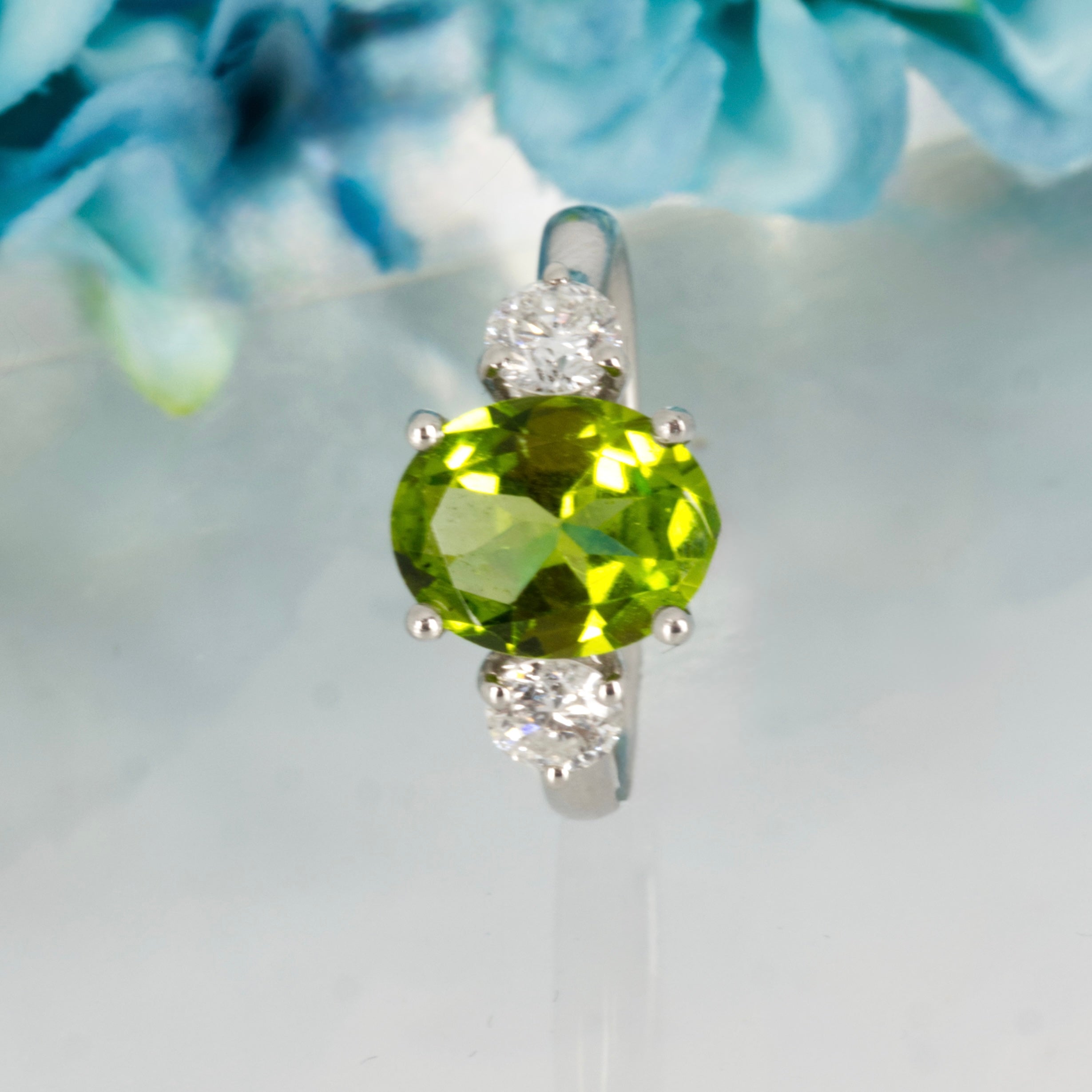 Platinum Oval Cut Peridot & Round Brilliant Cut Diamond Trilogy Ring