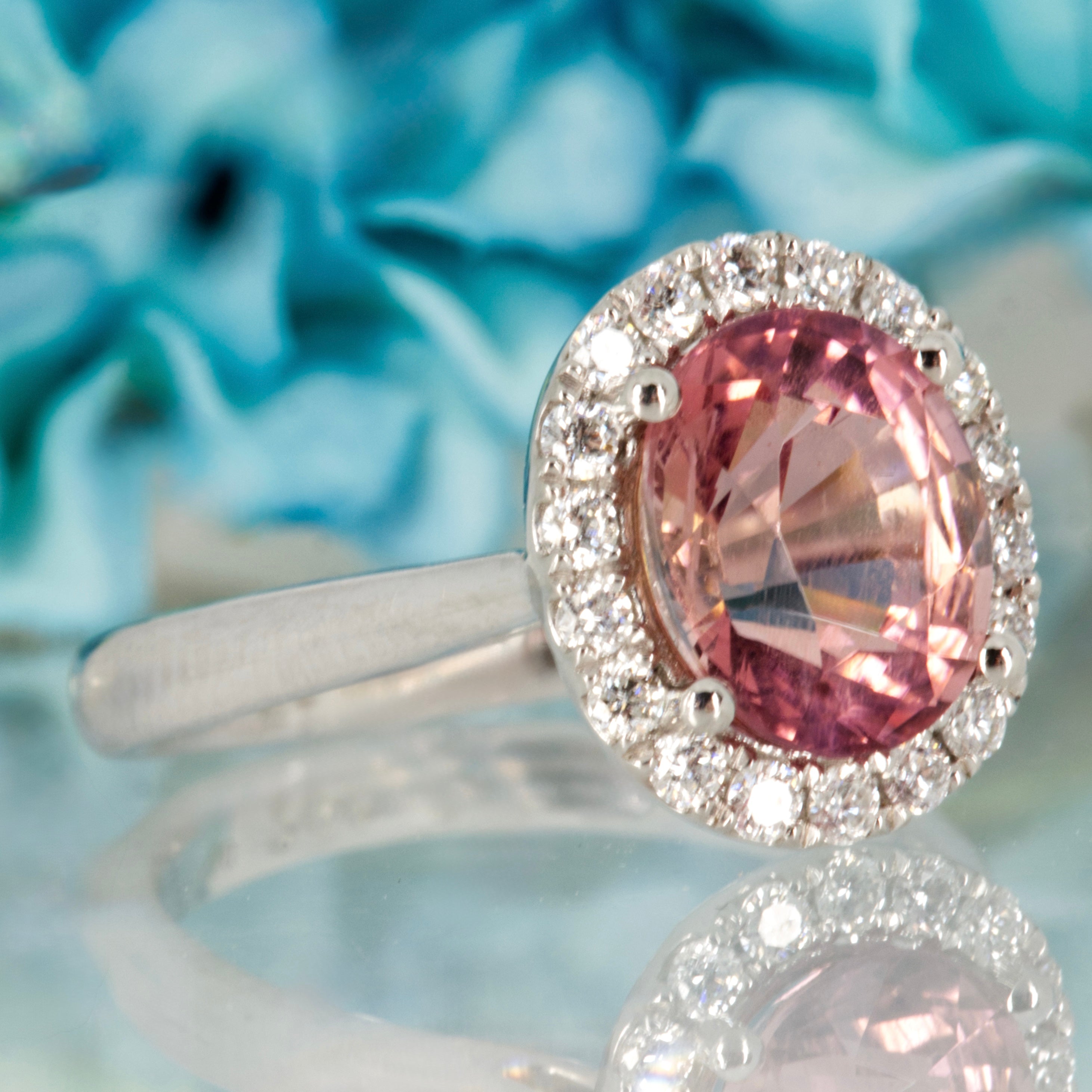 Platinum Oval Cut Pink Tourmaline & Round Brilliant Cut Diamond Halo Cluster Ring