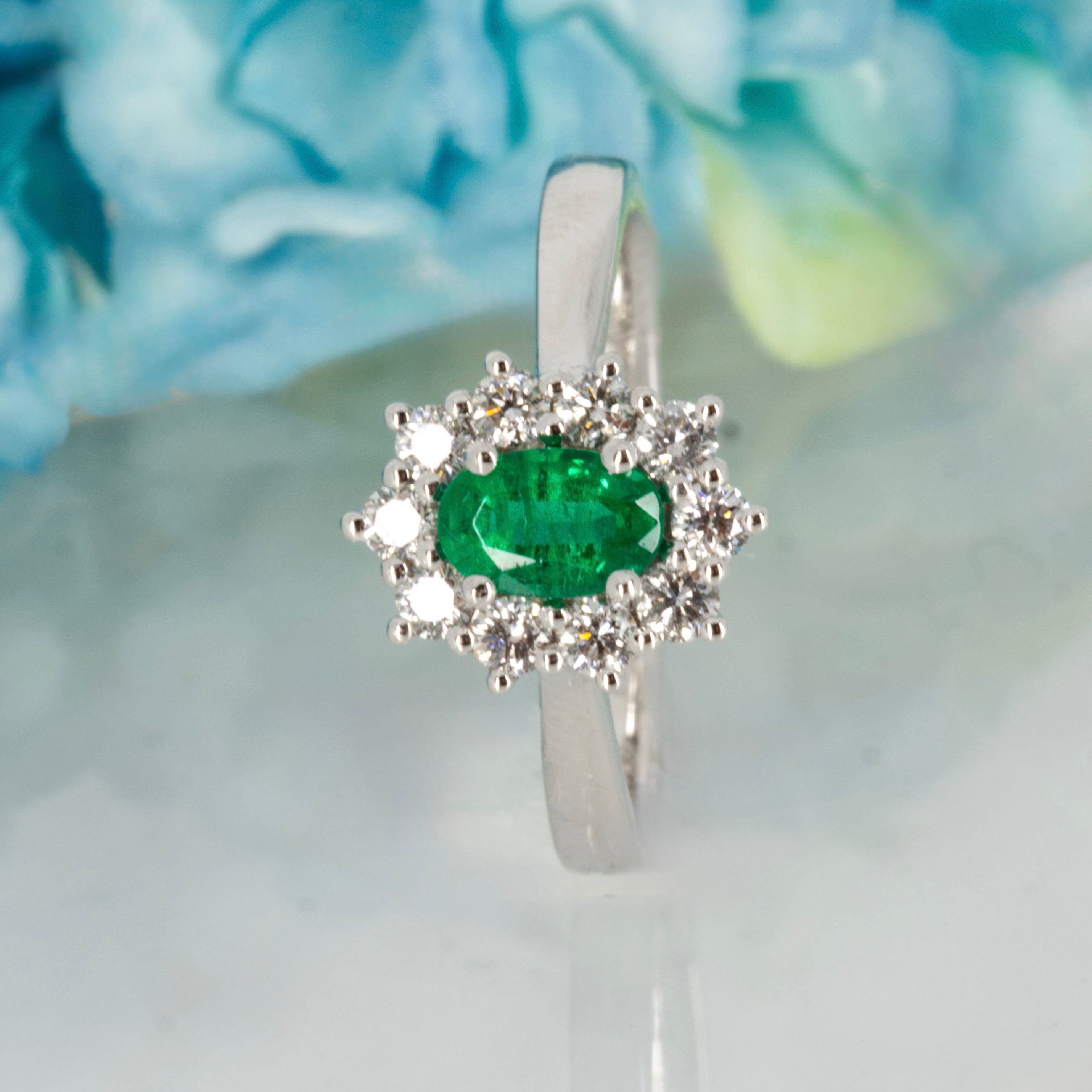 Platinum Oval Cut Emerald & Round Brilliant Cut Diamond Cluster Ring