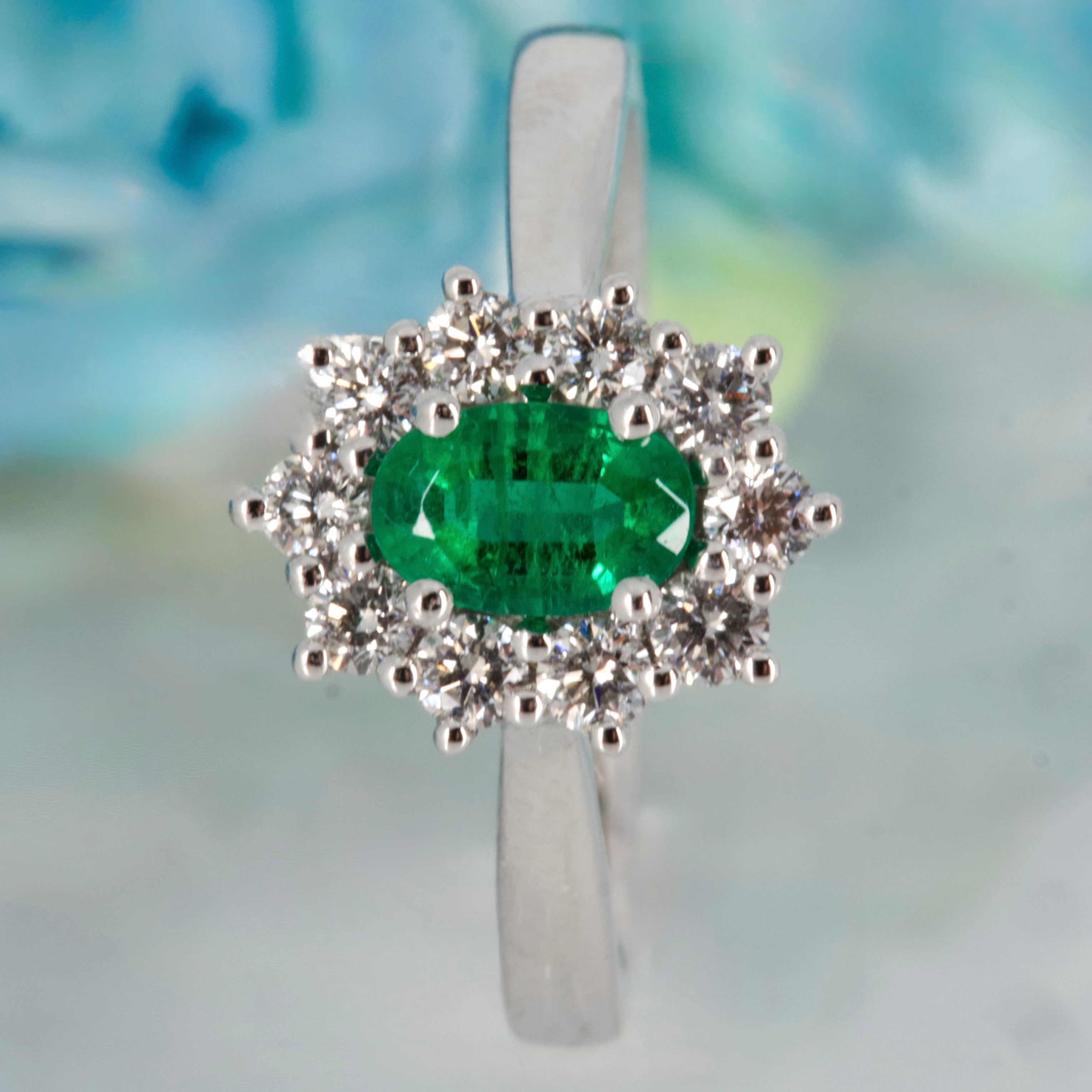 Platinum Oval Cut Emerald & Round Brilliant Cut Diamond Cluster Ring