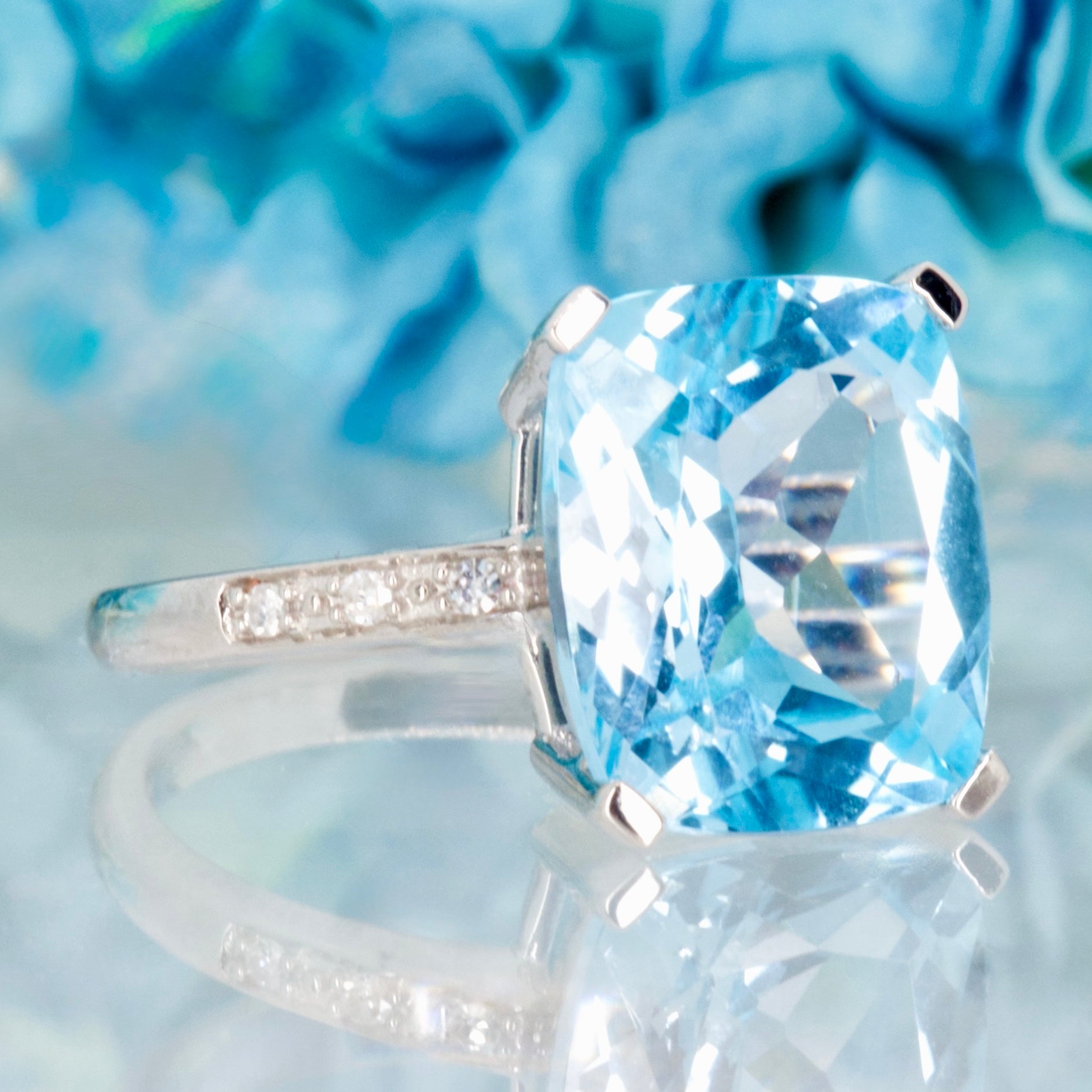 9ct White Gold Elongated Cushion Cut Blue Topaz & Round Brilliant Cut Diamond Ring