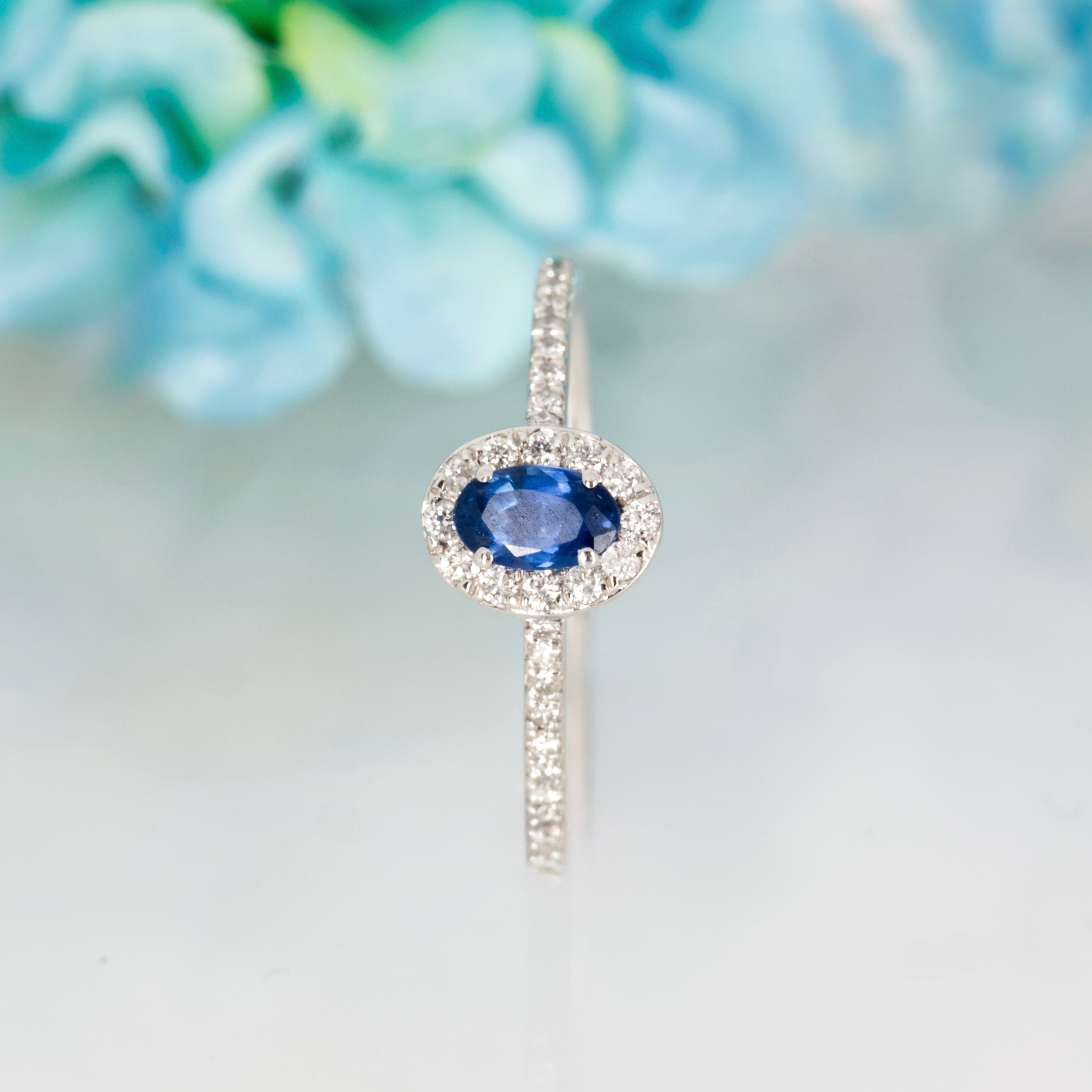 Platinum Oval Cut Sapphire & Round Brilliant Cut Diamond Halo Cluster Ring
