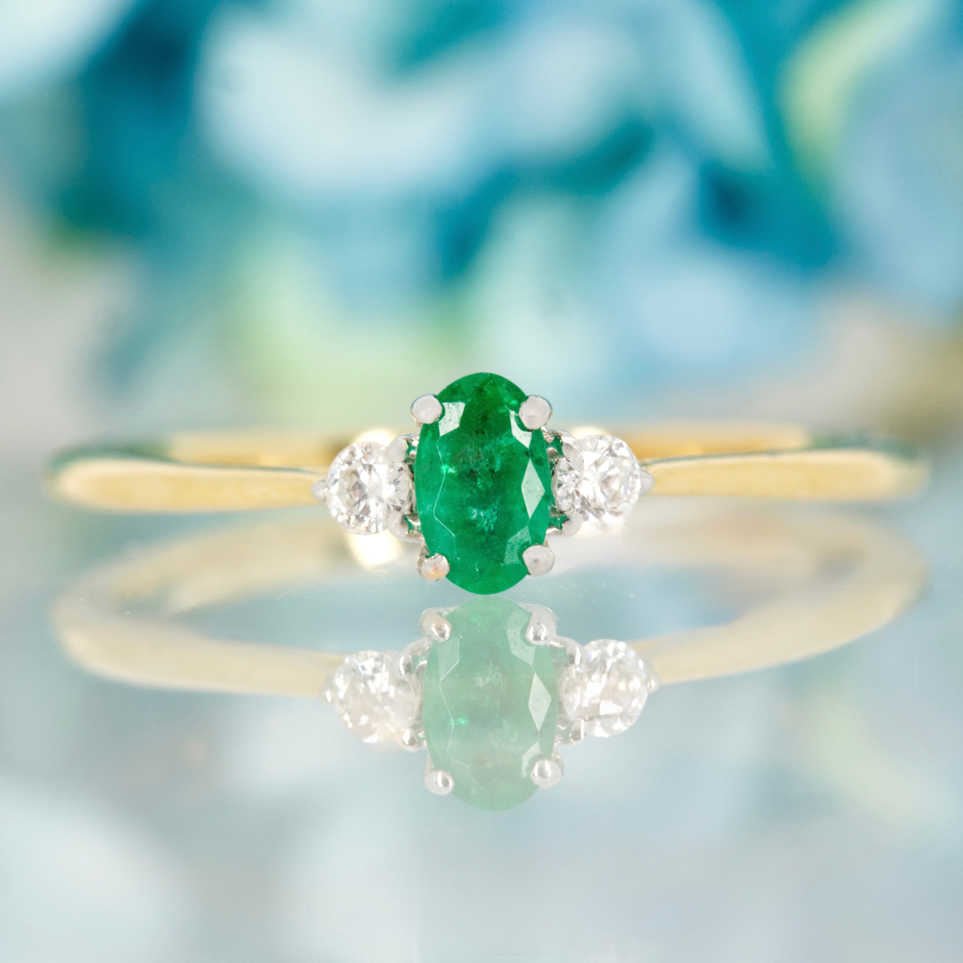 18ct Yellow Gold Oval Cut Emerald & Round Brilliant Cut Diamond Trilogy Ring