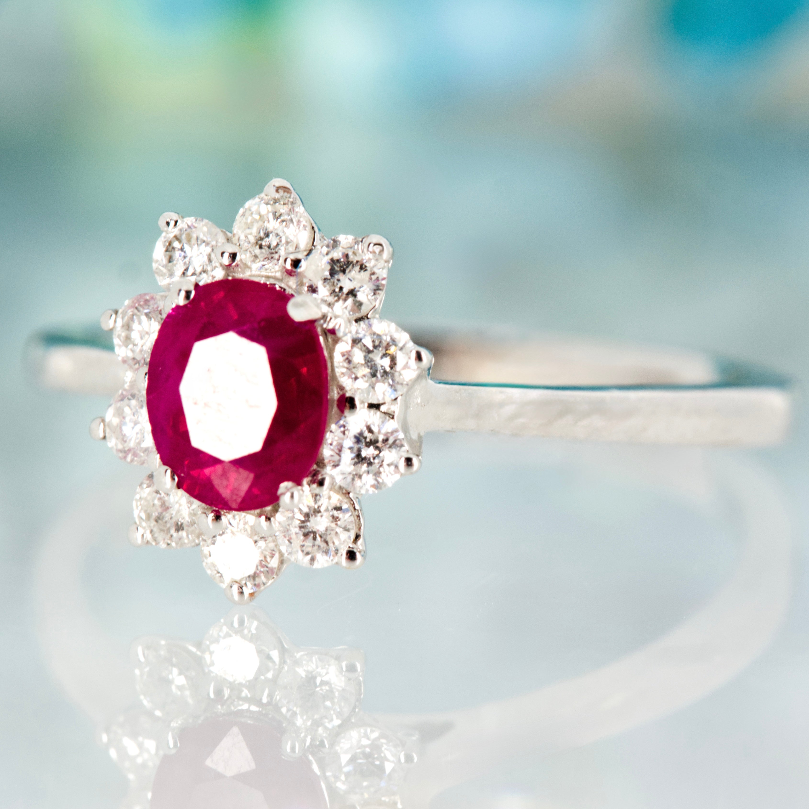 18ct White Gold Oval Cut Ruby & Round Brilliant Cut Diamond Cluster Ring