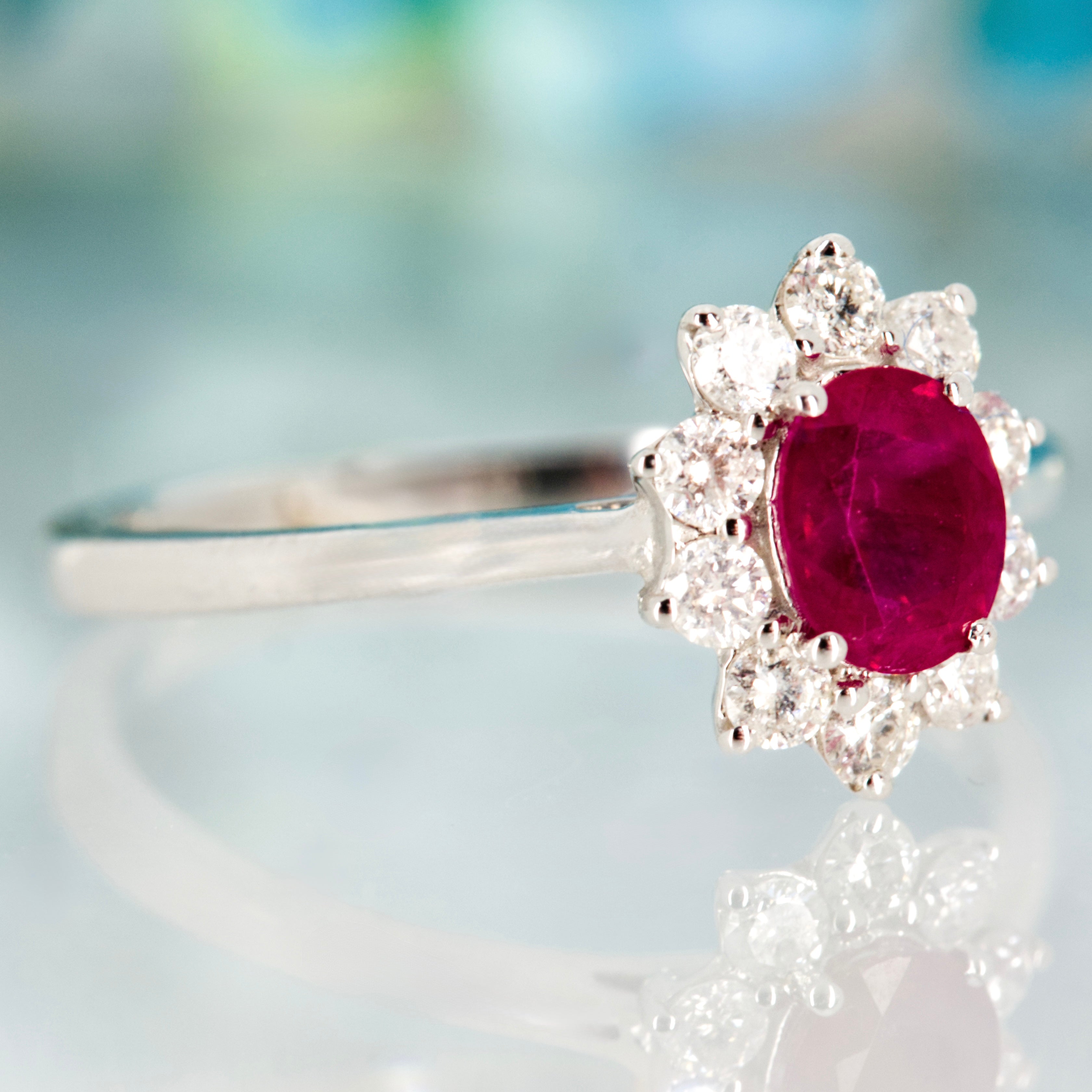 18ct White Gold Oval Cut Ruby & Round Brilliant Cut Diamond Cluster Ring