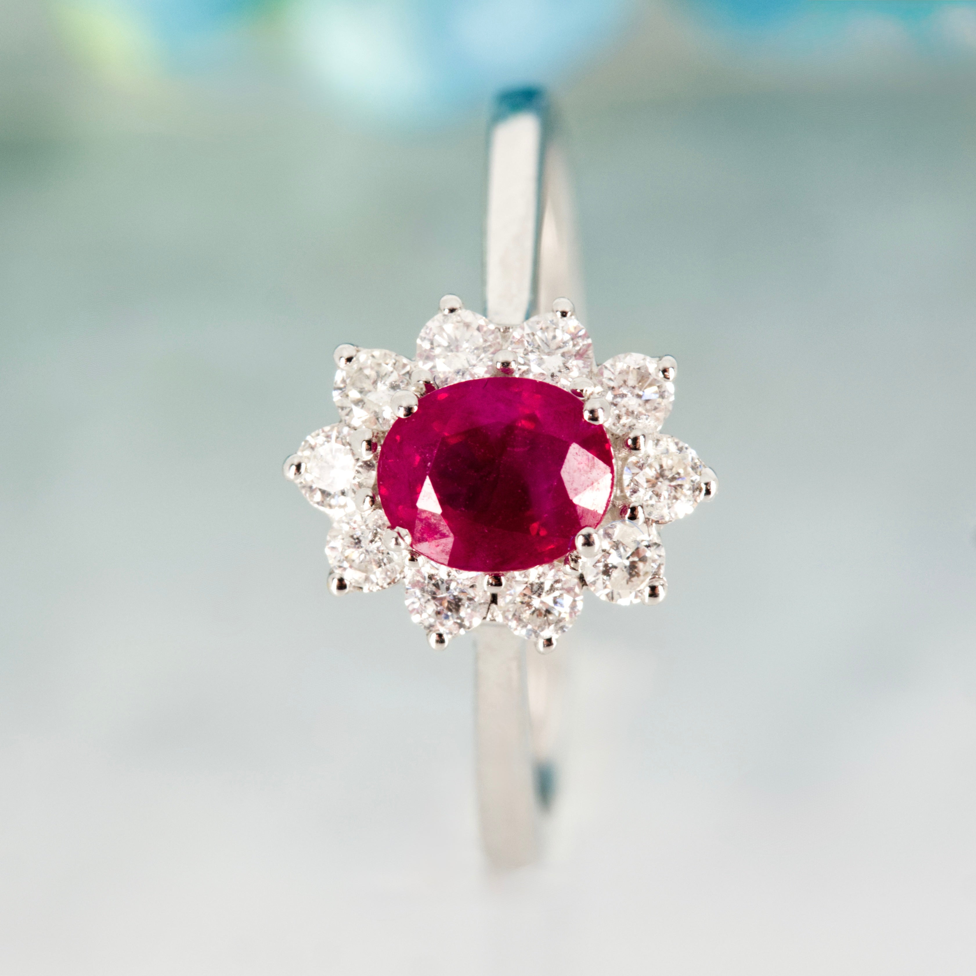18ct White Gold Oval Cut Ruby & Round Brilliant Cut Diamond Cluster Ring