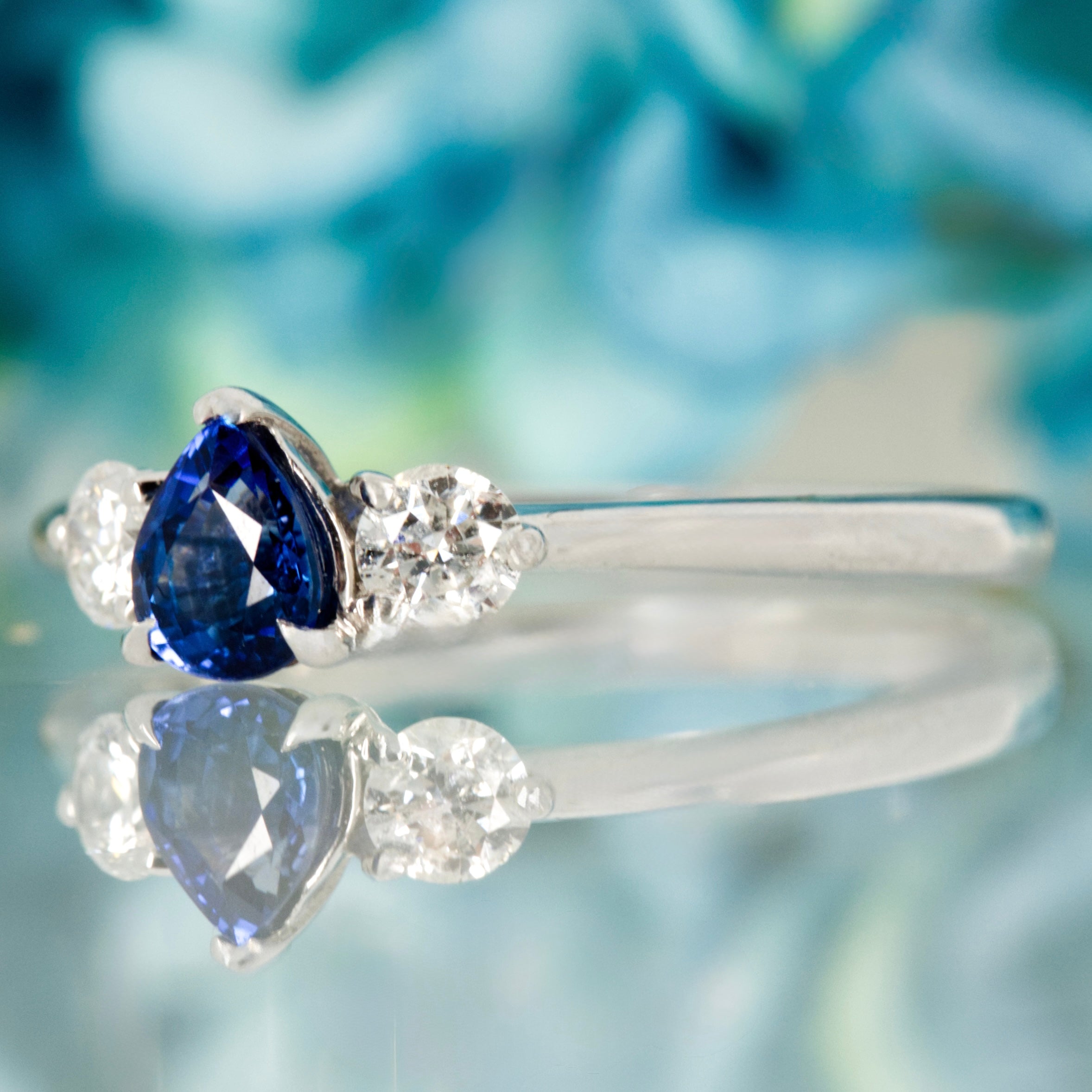 Platinum Pear Cut Sapphire & Round Brilliant Cut Diamond Trilogy Ring
