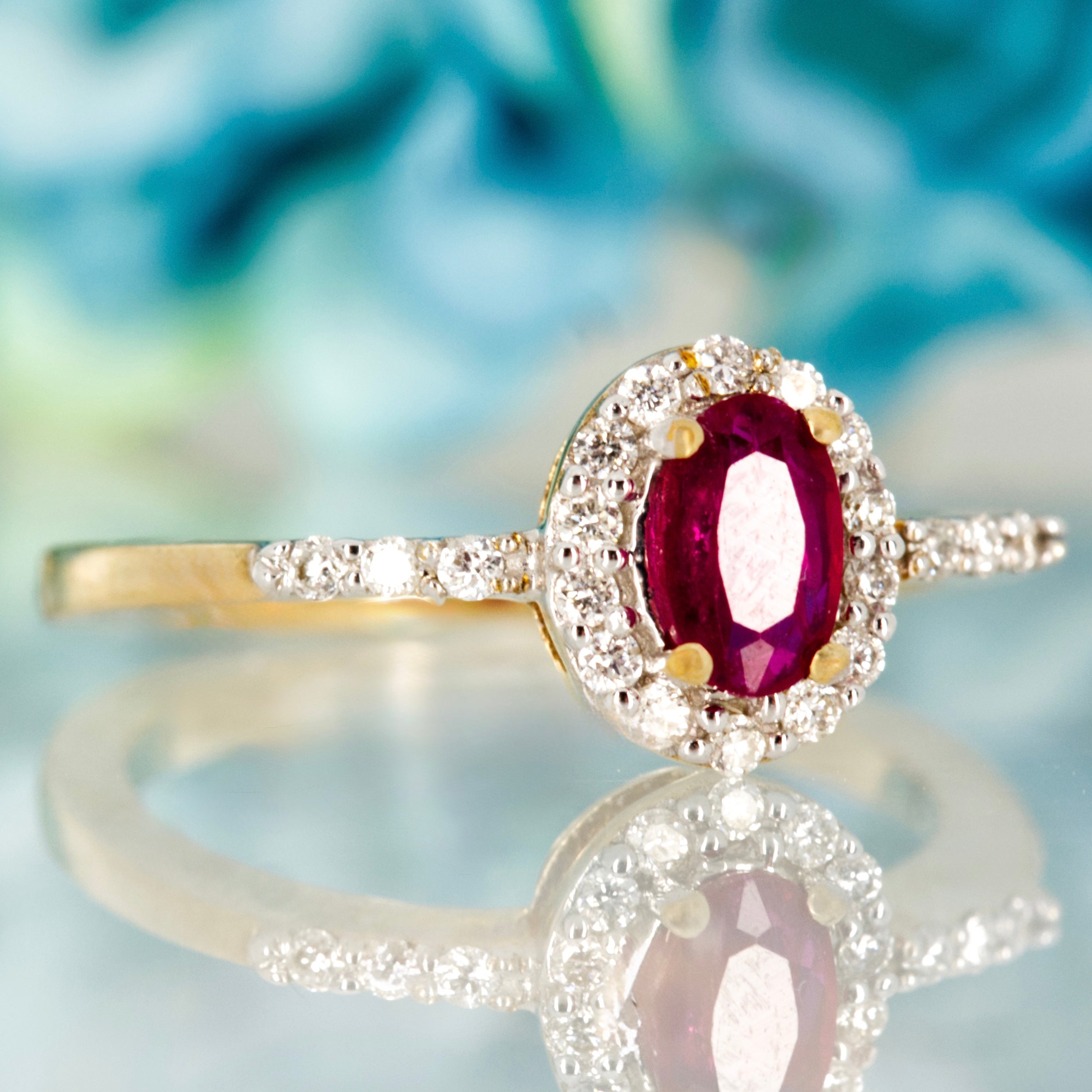 9ct Yellow Gold Oval Cut Ruby & Round Brilliant Cut Diamond Halo Cluster Ring