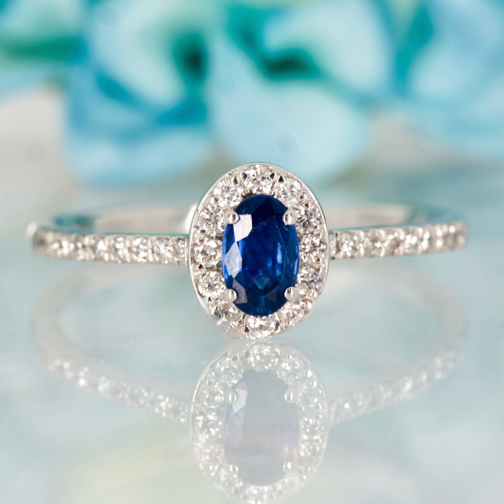 Platinum Oval Cut Sapphire & Round Brilliant Cut Diamond Halo Cluster Ring