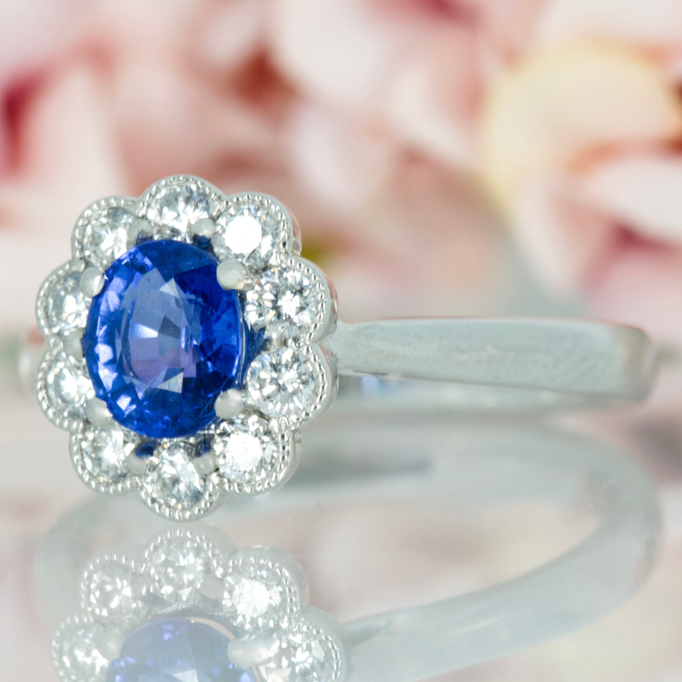 Platinum Oval Cut Sapphire & Round Brilliant Cut Diamond Cluster Ring
