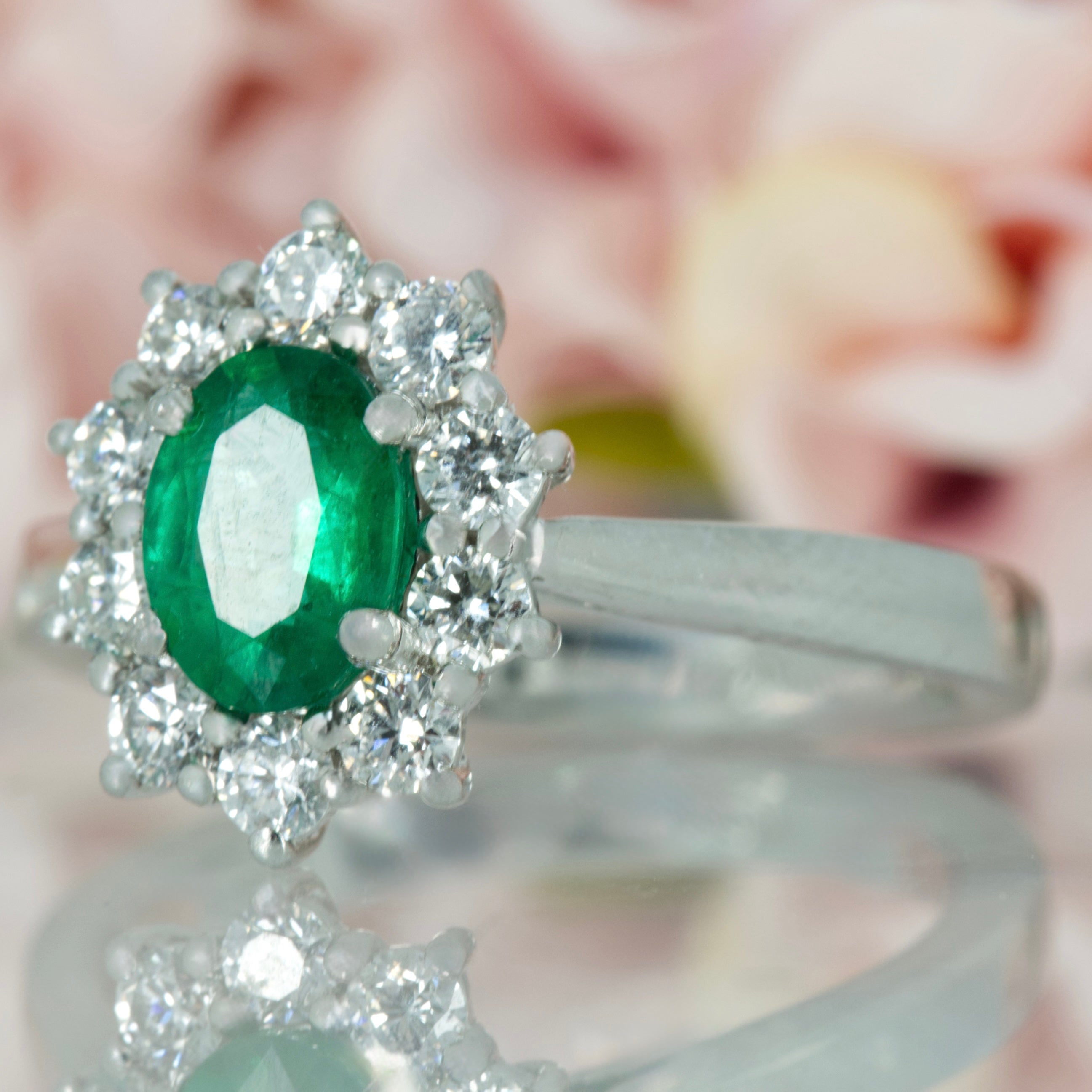 Platinum Oval Cut Emerald & Round Brilliant Cut Diamond Cluster Ring