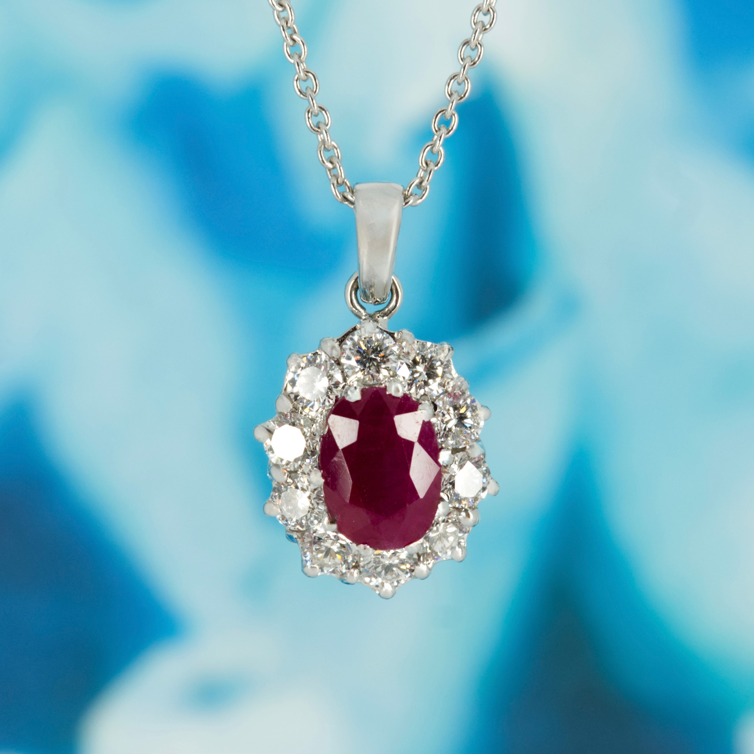 18ct White Gold Oval Cut Ruby & Round Brilliant Cut Diamond Cluster Pendant & Chain