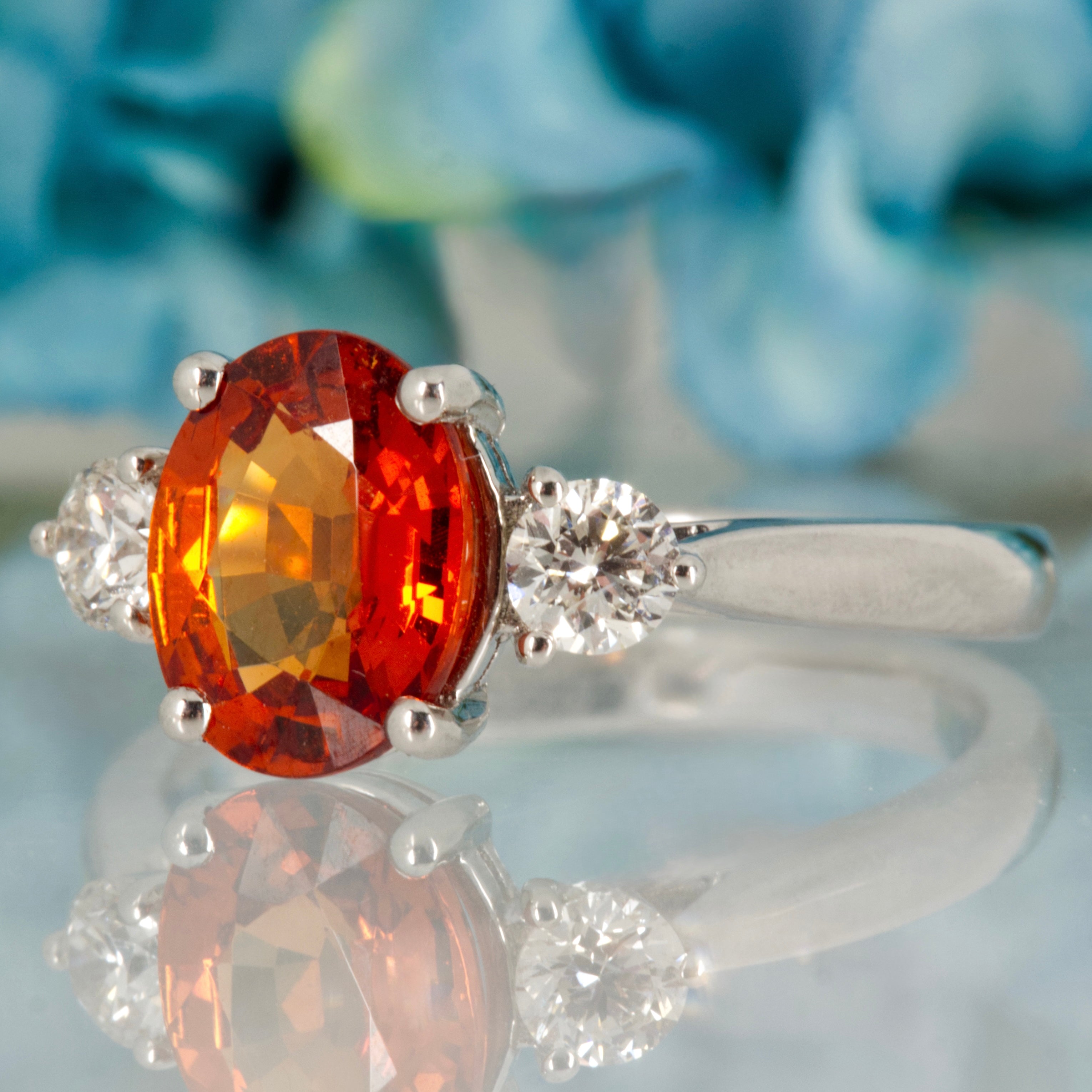Platinum Oval Cut Mandarin Garnet & Round Brilliant Cut Diamond Trilogy Ring