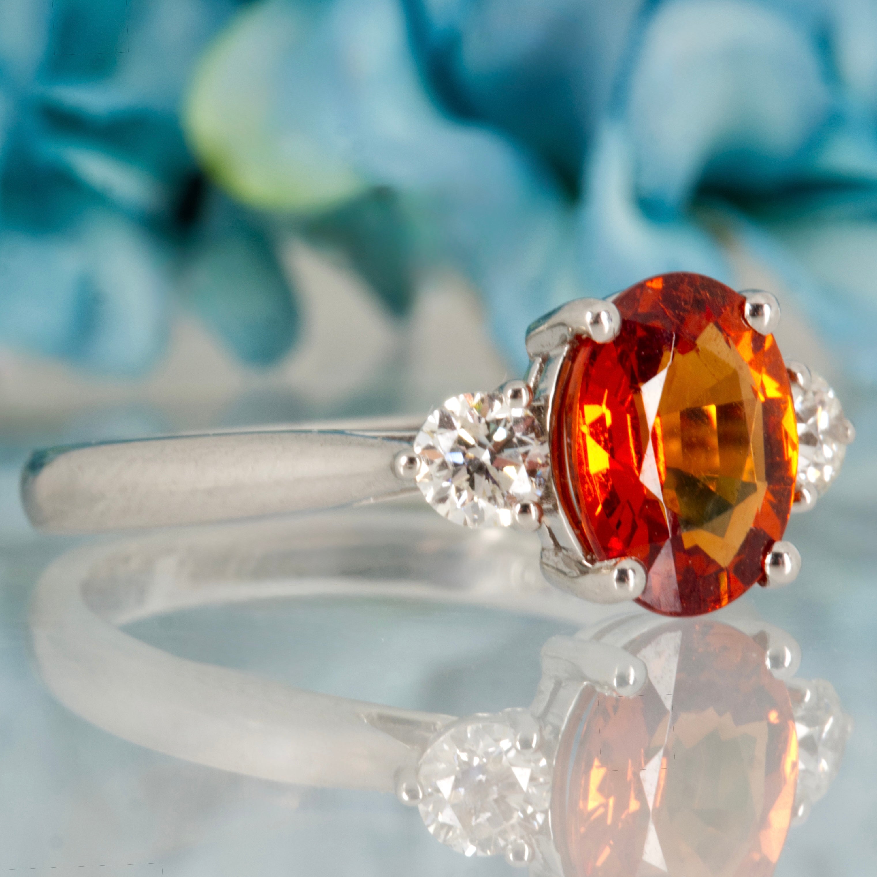 Platinum Oval Cut Mandarin Garnet & Round Brilliant Cut Diamond Trilogy Ring