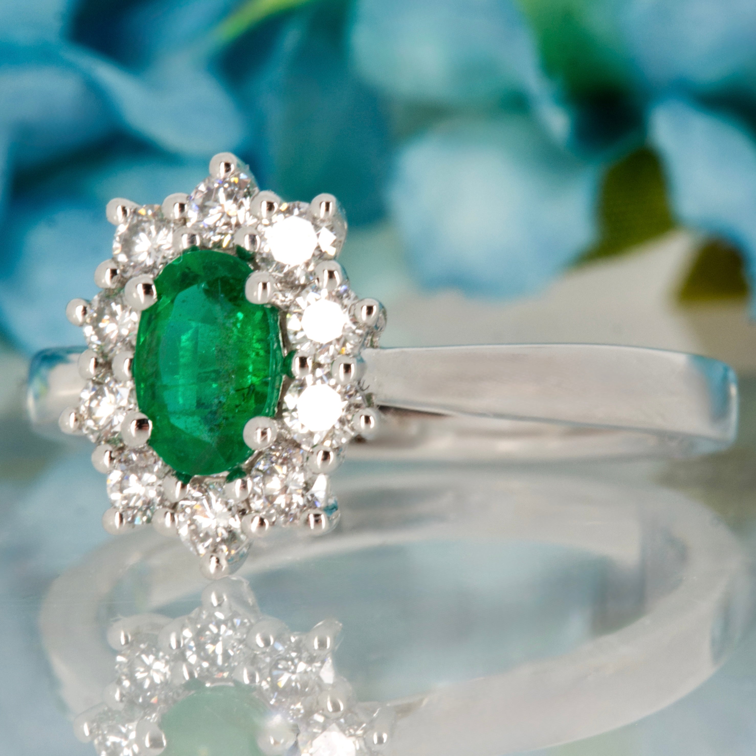 Platinum Oval Cut Emerald & Round Brilliant Cut Diamond Cluster Ring