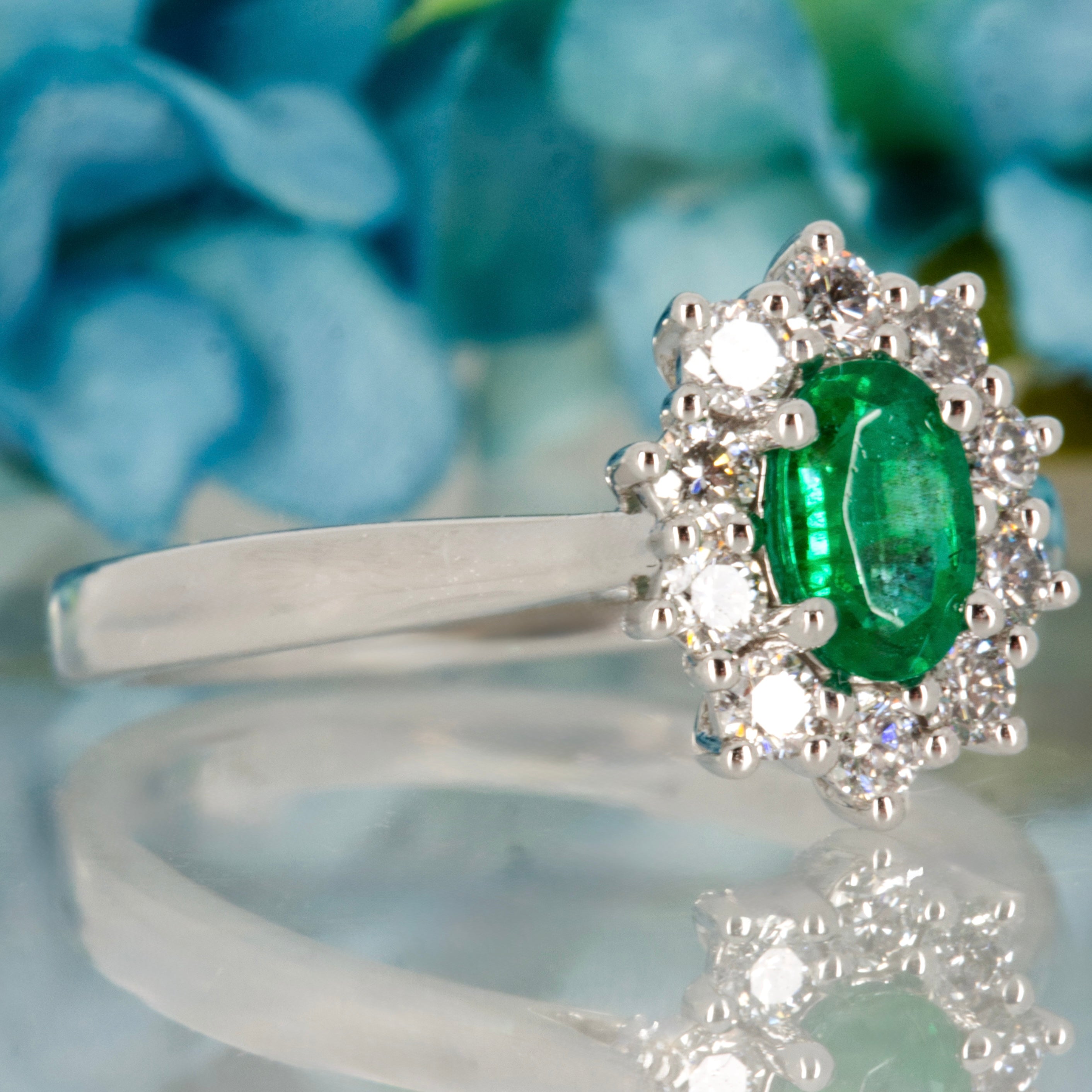 Platinum Oval Cut Emerald & Round Brilliant Cut Diamond Cluster Ring