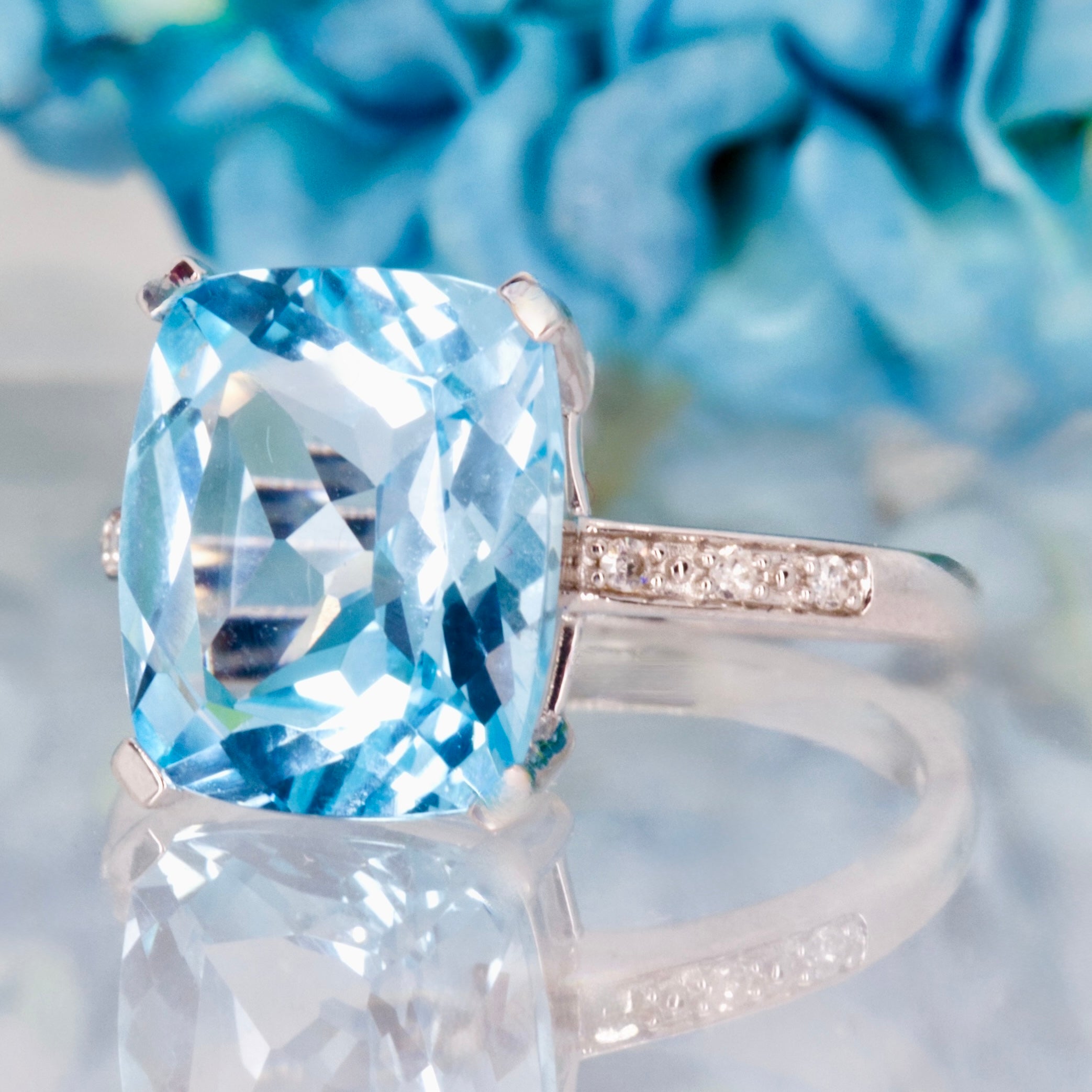 9ct White Gold Elongated Cushion Cut Blue Topaz & Round Brilliant Cut Diamond Ring
