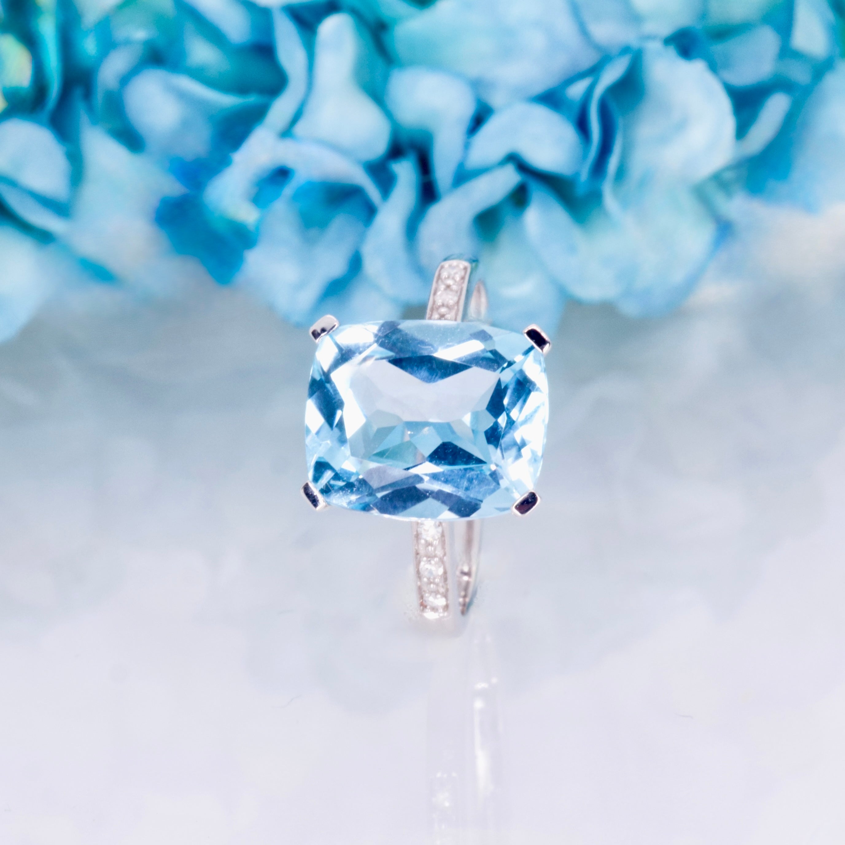 9ct White Gold Elongated Cushion Cut Blue Topaz & Round Brilliant Cut Diamond Ring