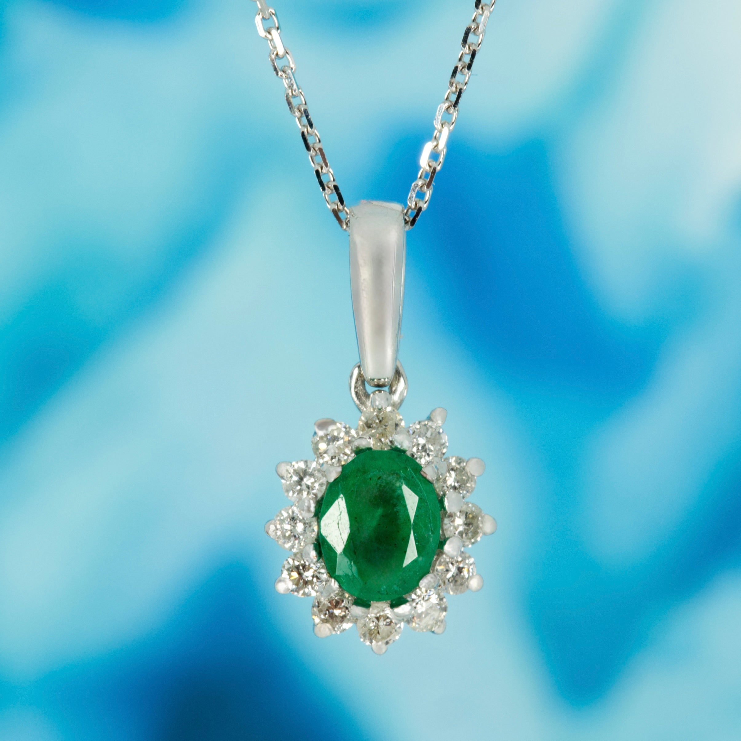 9ct White Gold Oval Cut Emerald & Round Brilliant Cut Diamond Cluster Pendant & Chain