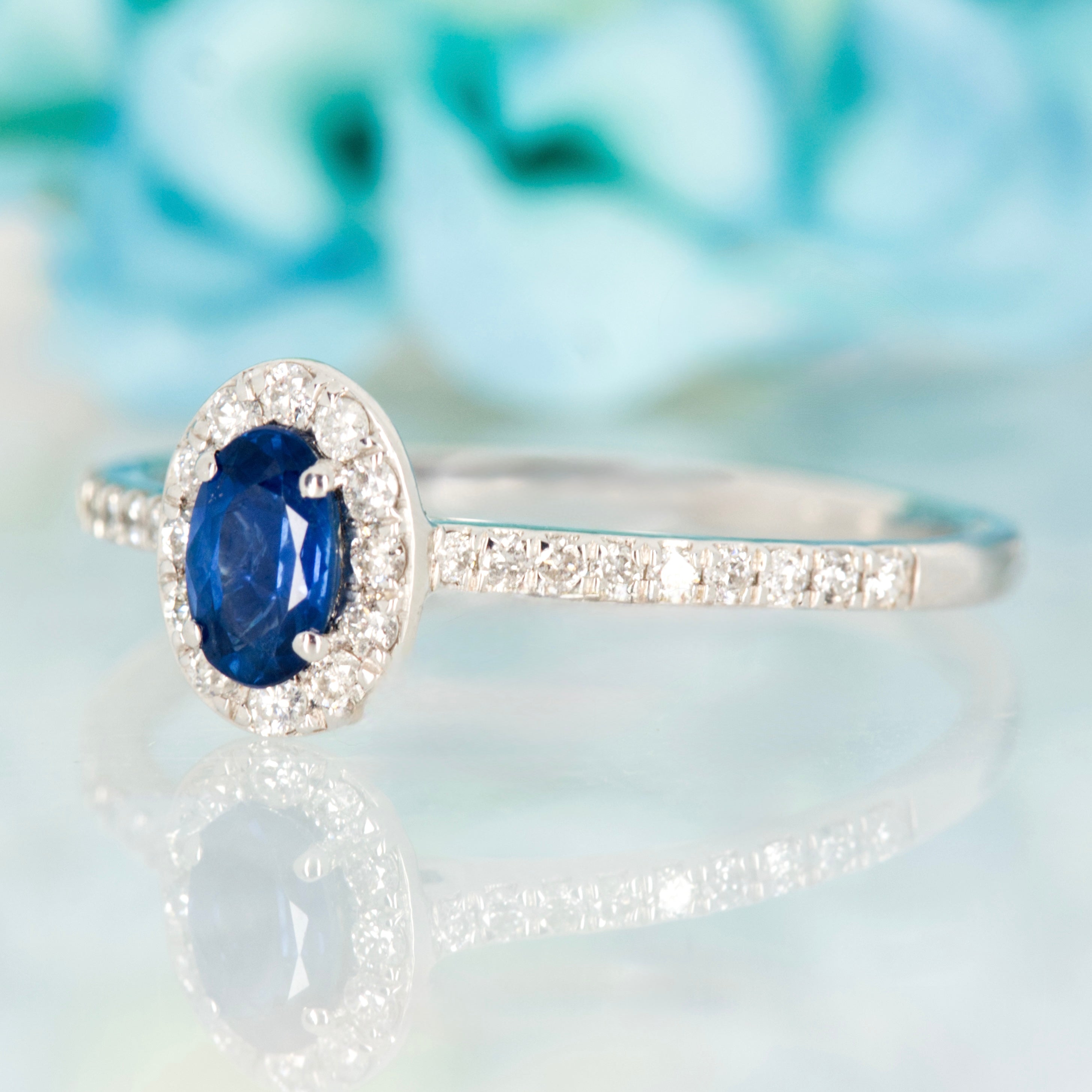Platinum Oval Cut Sapphire & Round Brilliant Cut Diamond Halo Cluster Ring