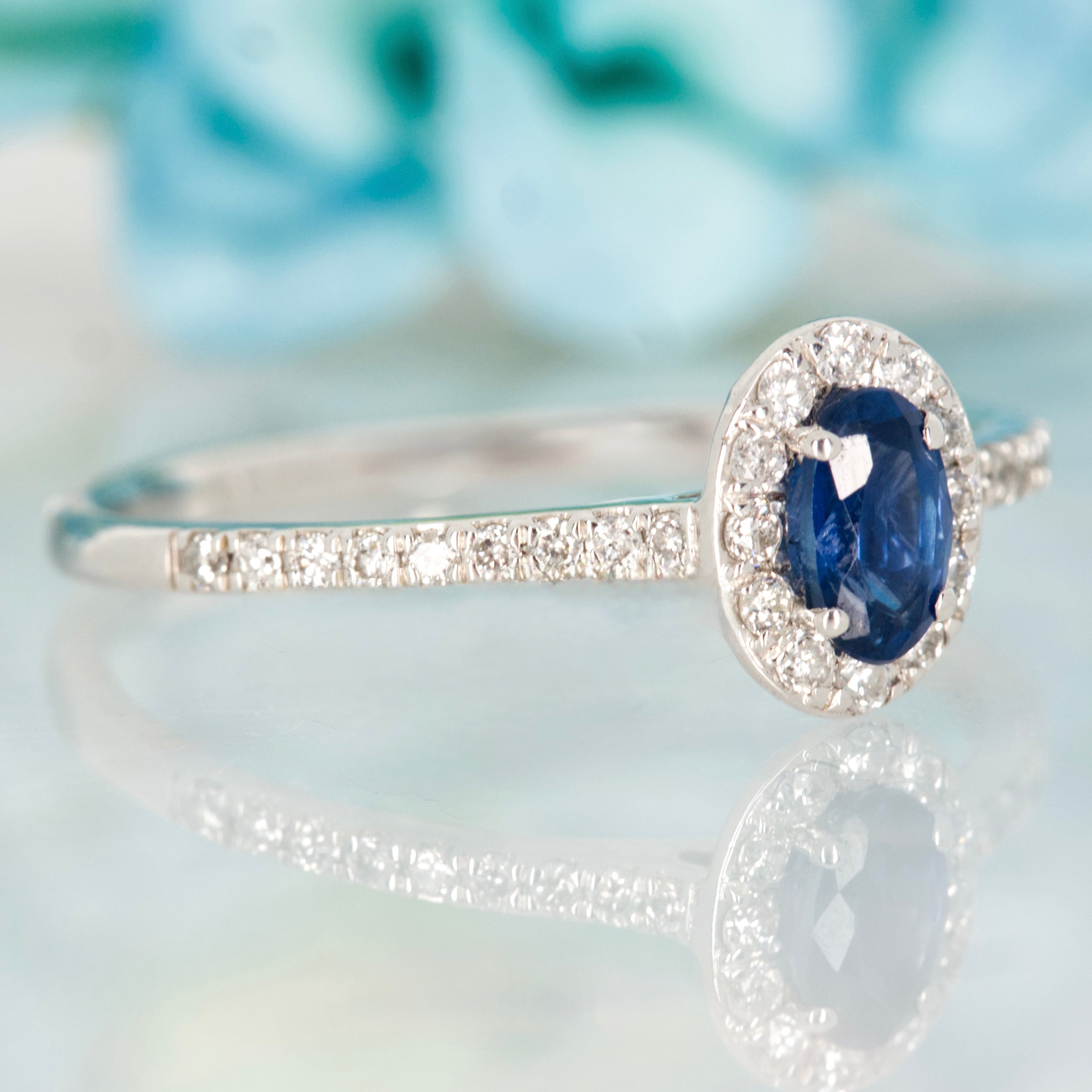 Platinum Oval Cut Sapphire & Round Brilliant Cut Diamond Halo Cluster Ring