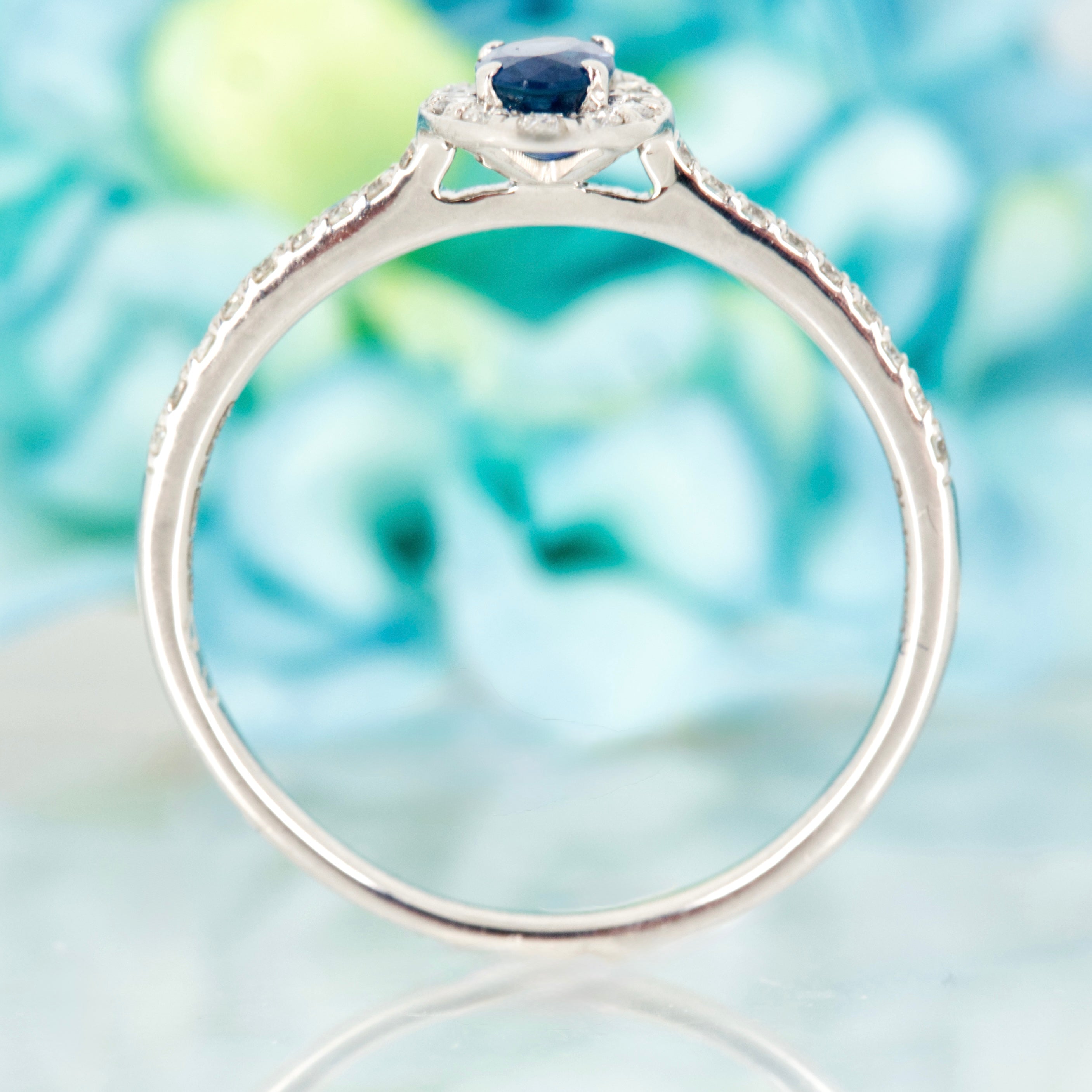 Platinum Oval Cut Sapphire & Round Brilliant Cut Diamond Halo Cluster Ring