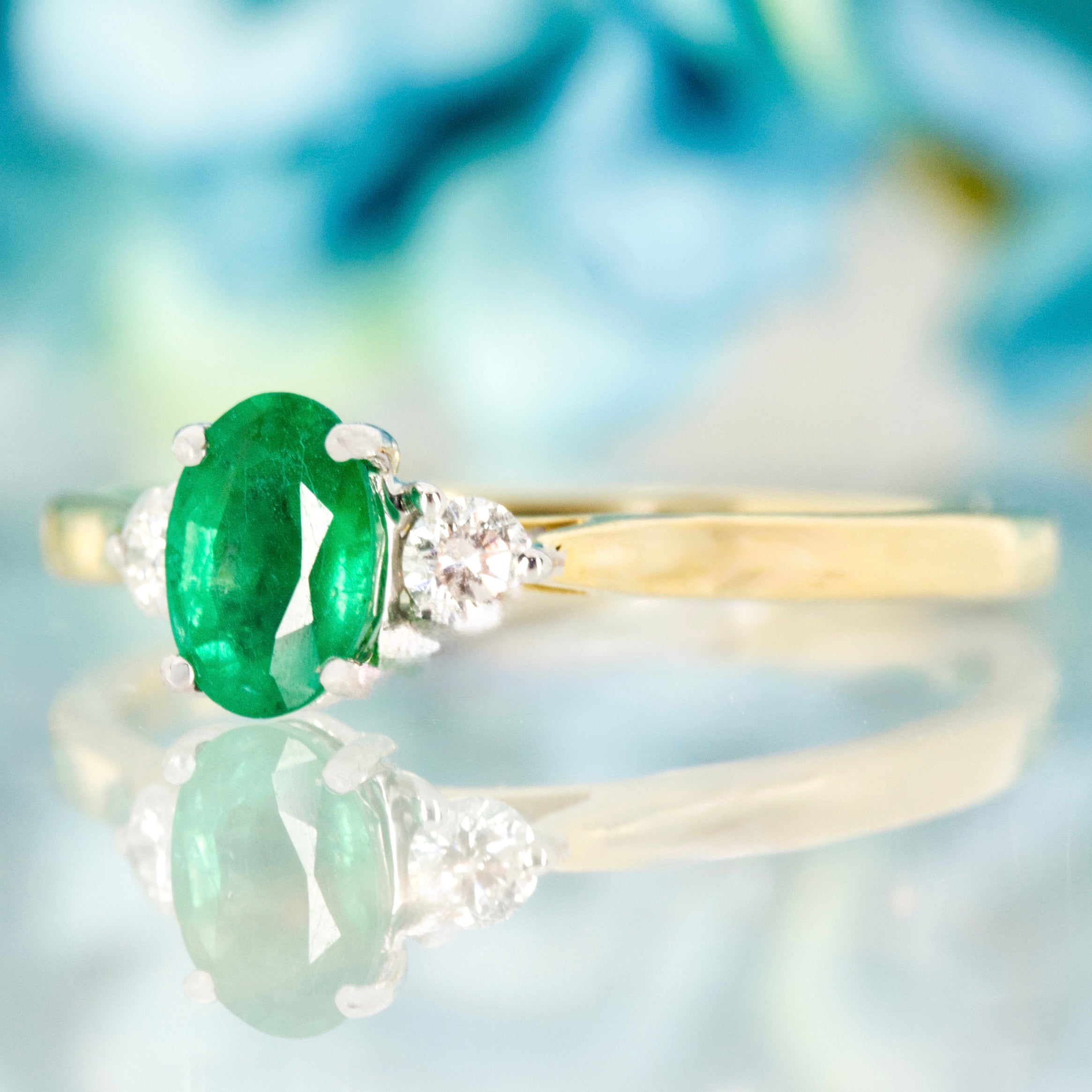 18ct Yellow Gold Oval Cut Emerald & Round Brilliant Cut Diamond Trilogy Ring