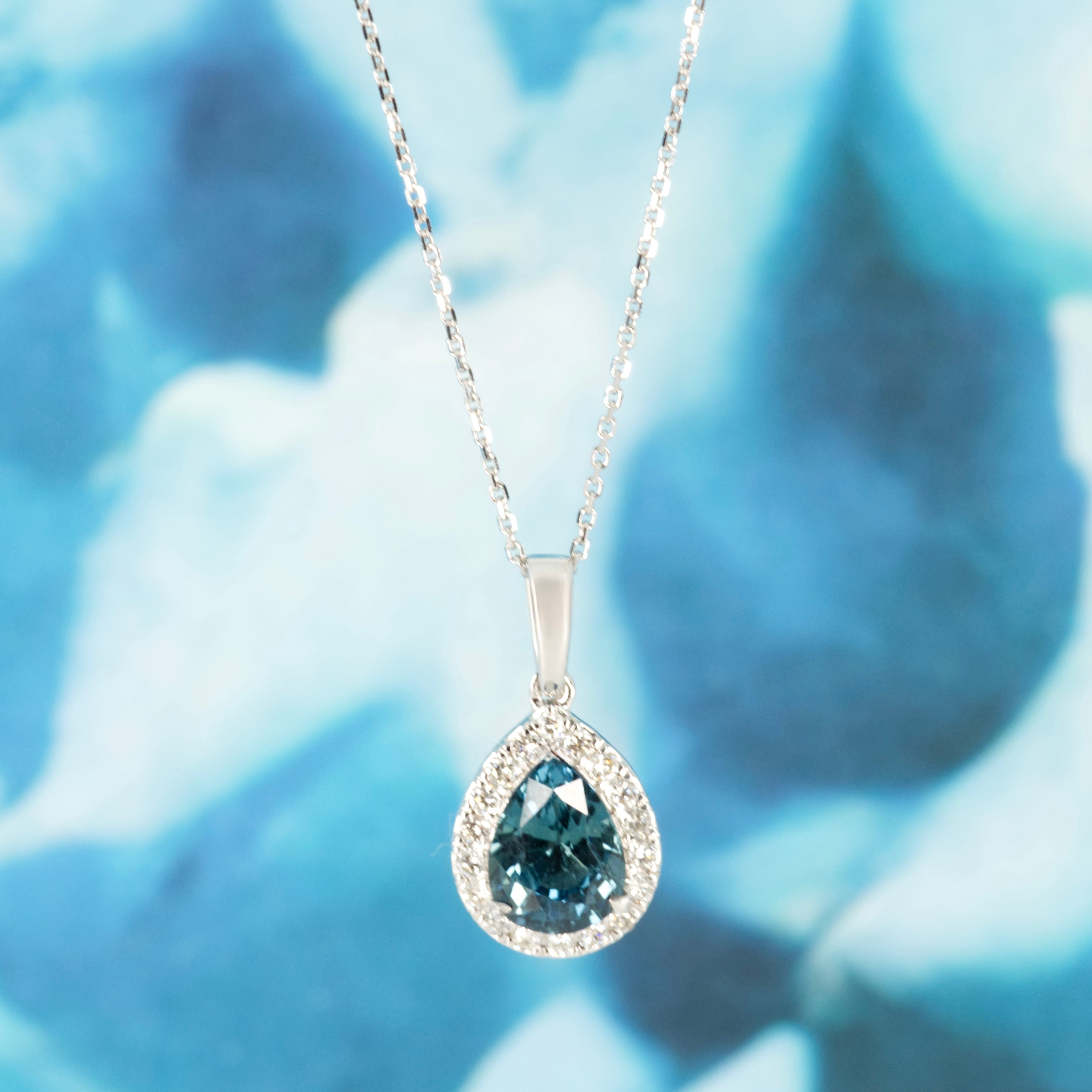9ct White Gold Pear Cut Teal Sapphire & Round Brilliant Cut Diamond Halo Cluster Pendant & Chain