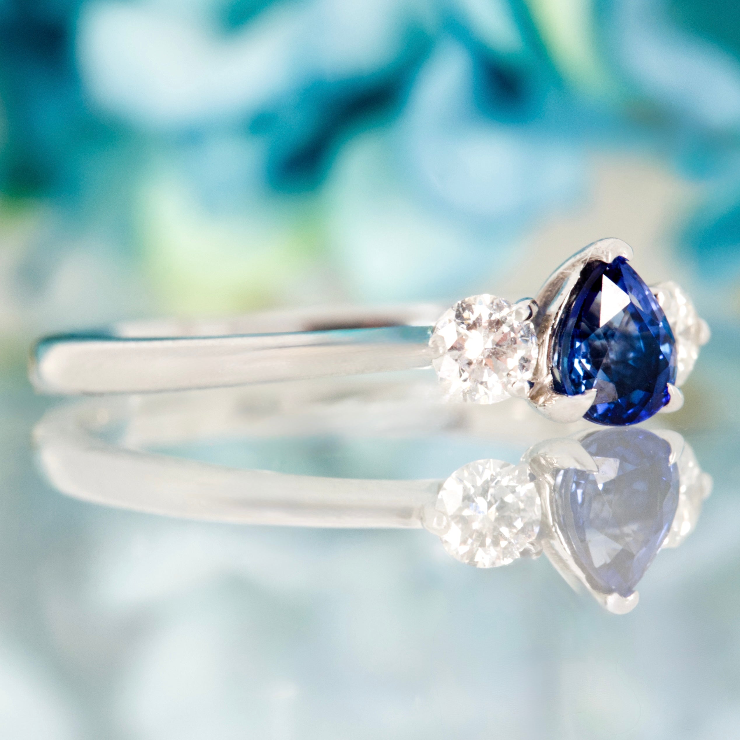 Platinum Pear Cut Sapphire & Round Brilliant Cut Diamond Trilogy Ring