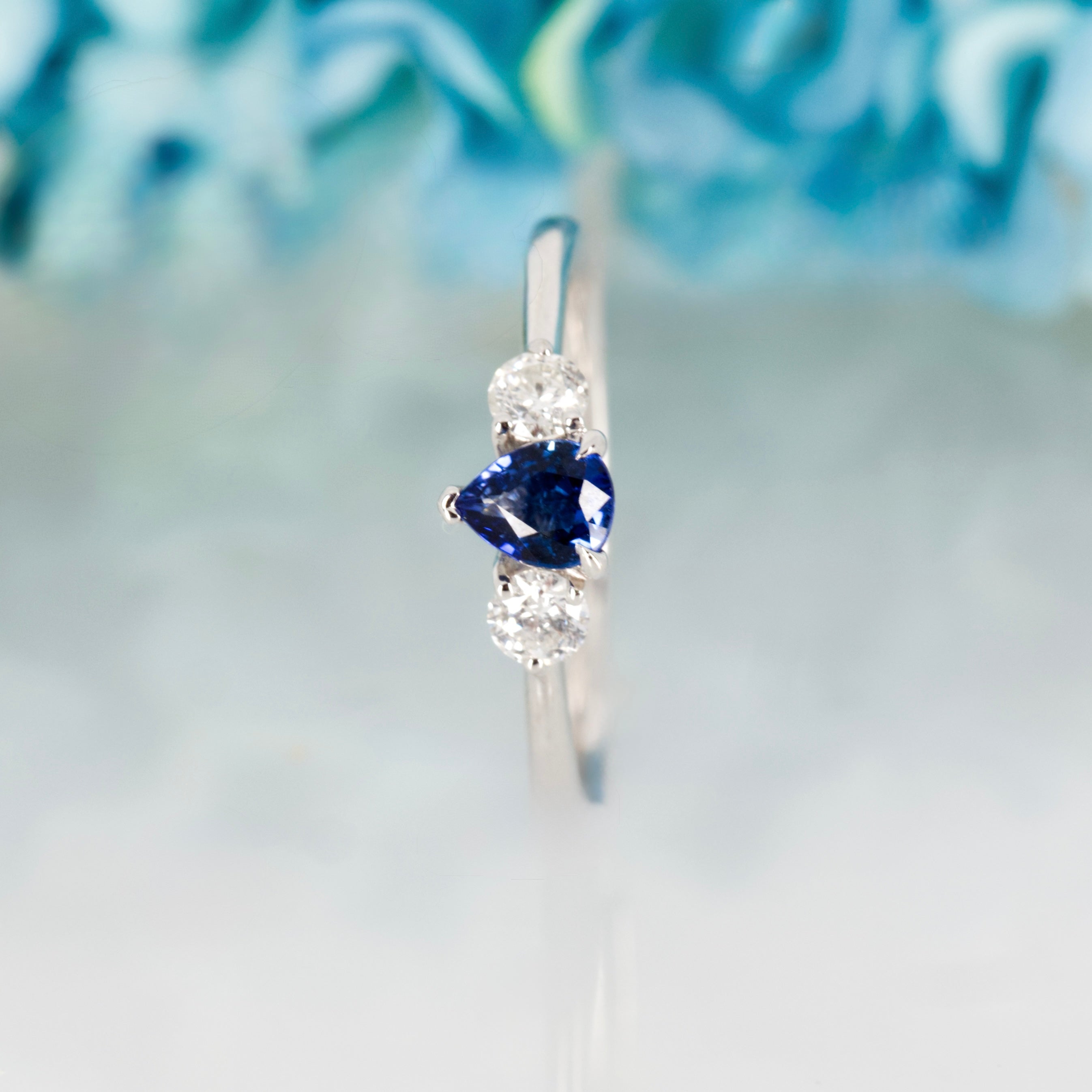 Platinum Pear Cut Sapphire & Round Brilliant Cut Diamond Trilogy Ring