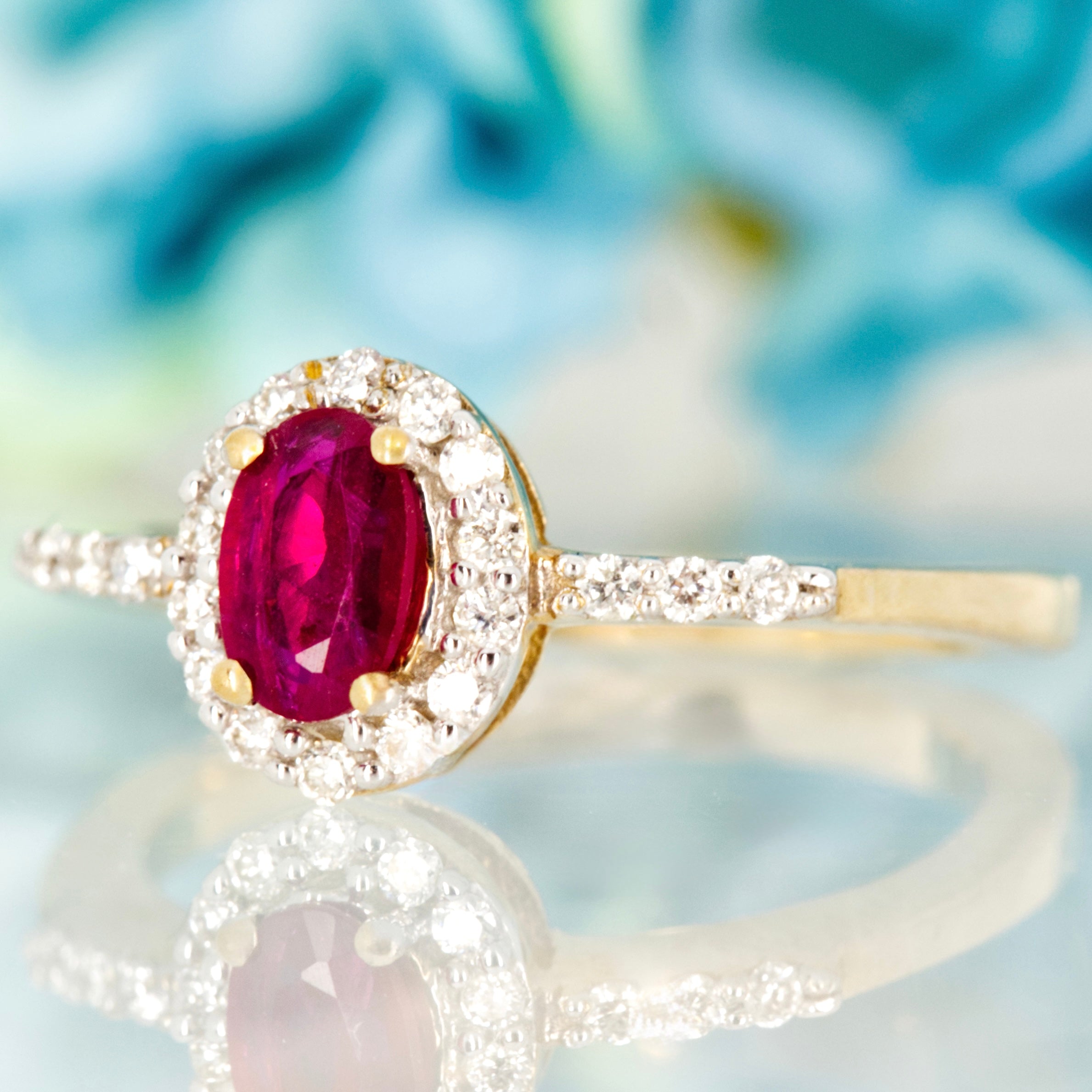 9ct Yellow Gold Oval Cut Ruby & Round Brilliant Cut Diamond Halo Cluster Ring