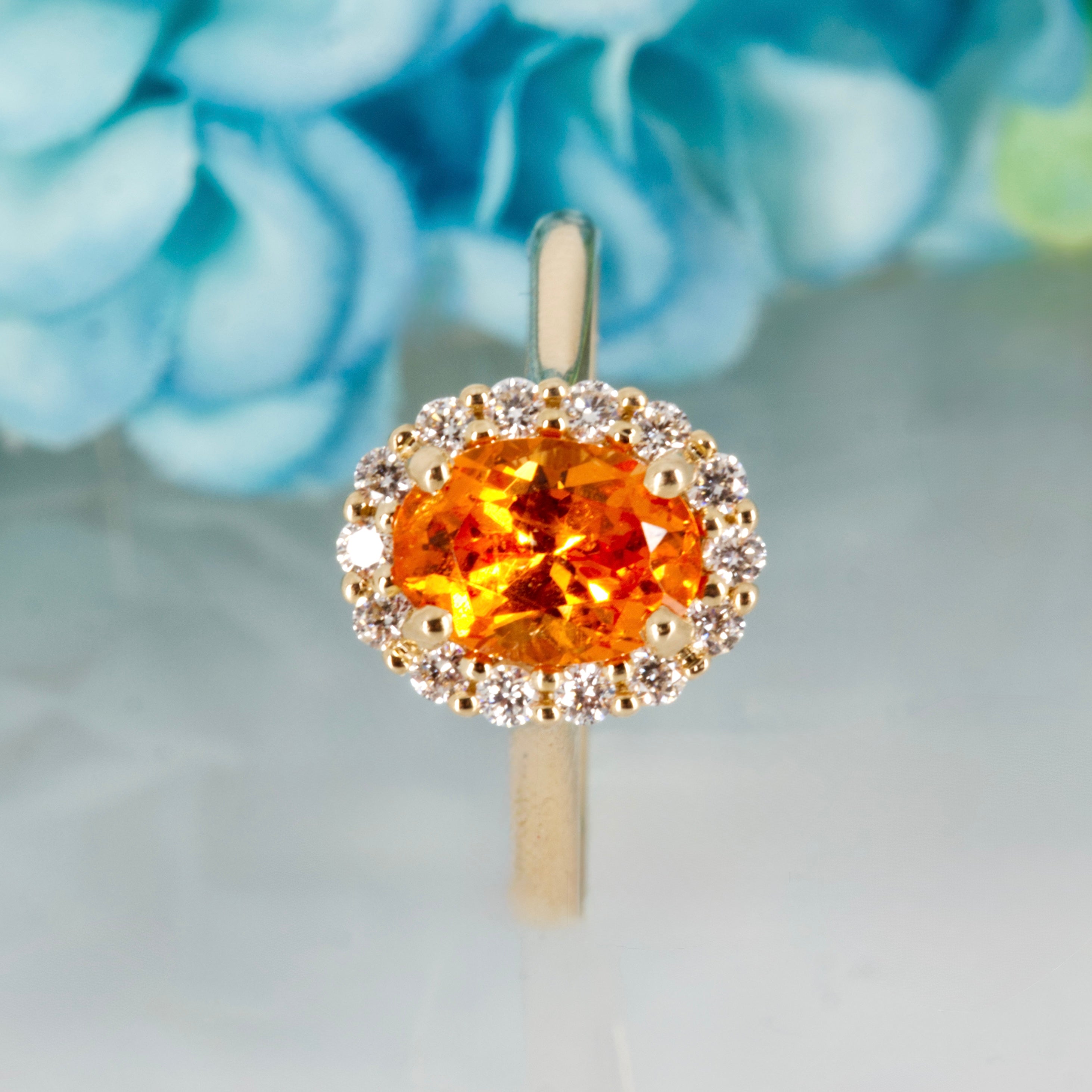 9ct Yellow Gold Oval Cut Spessartite Garnet & Round Brilliant Cut Diamond Halo Cluster Ring